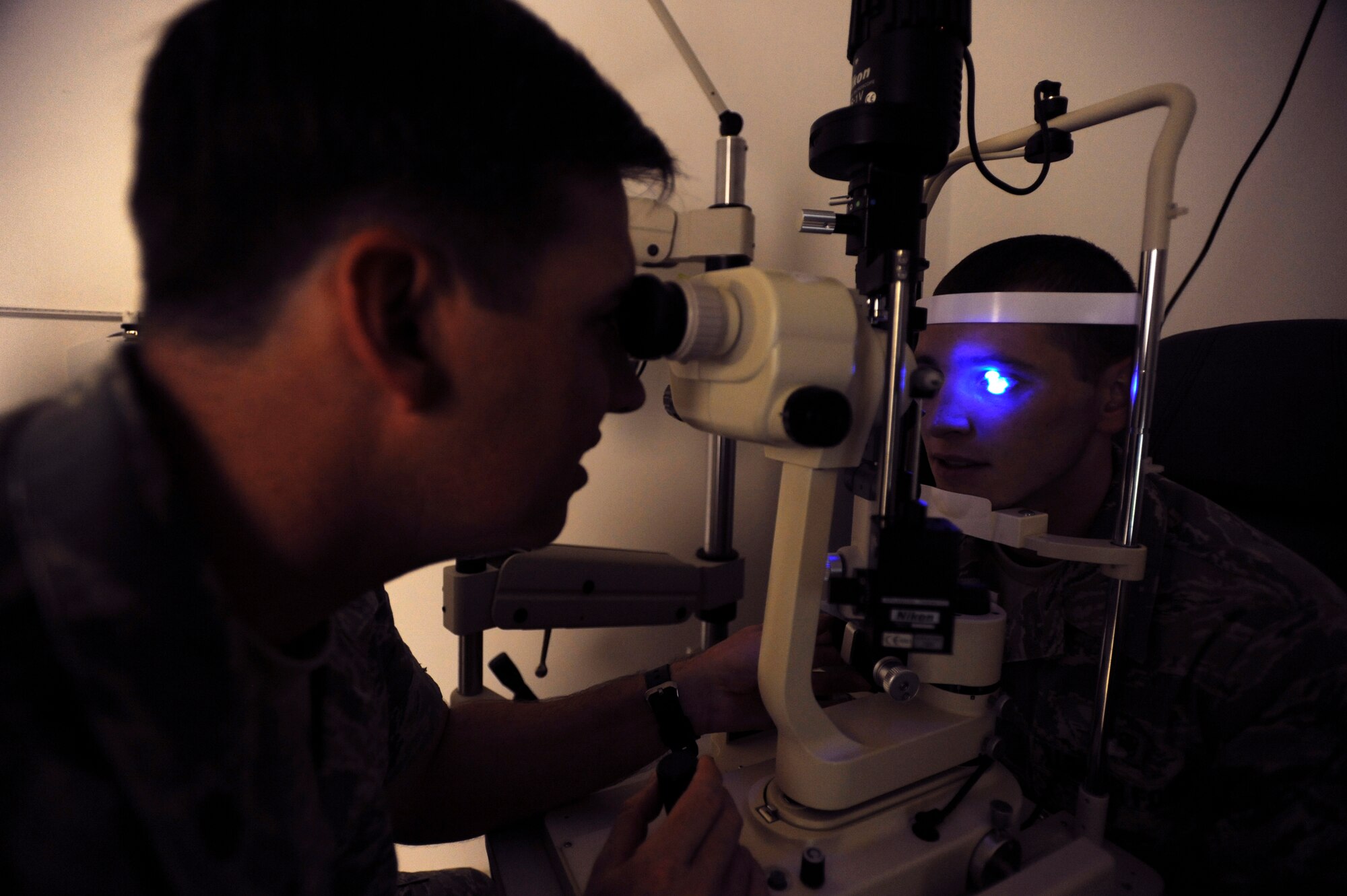 Major Neil Horner, an optometrist with the 379th Expeditionary Medical Group, uses a slit-lamp to evaluate the ocular health of the outer eye on a patient, May 28, 2009, in an undisclosed location in Southwest Asia.  The blue light works alongside a dye that allows Maj. Horner to see if there are any corneal abrasions.  Maj. Horner is native to Castroville, Texas and deployed from Lackland Air Force Base, Texas in support of Operations Iraqi and Enduring Freedom and Combined Joint Task Force - Horn of Africa.  (U.S. Air Force Photo by Staff Sgt. Joshua Garcia/released)