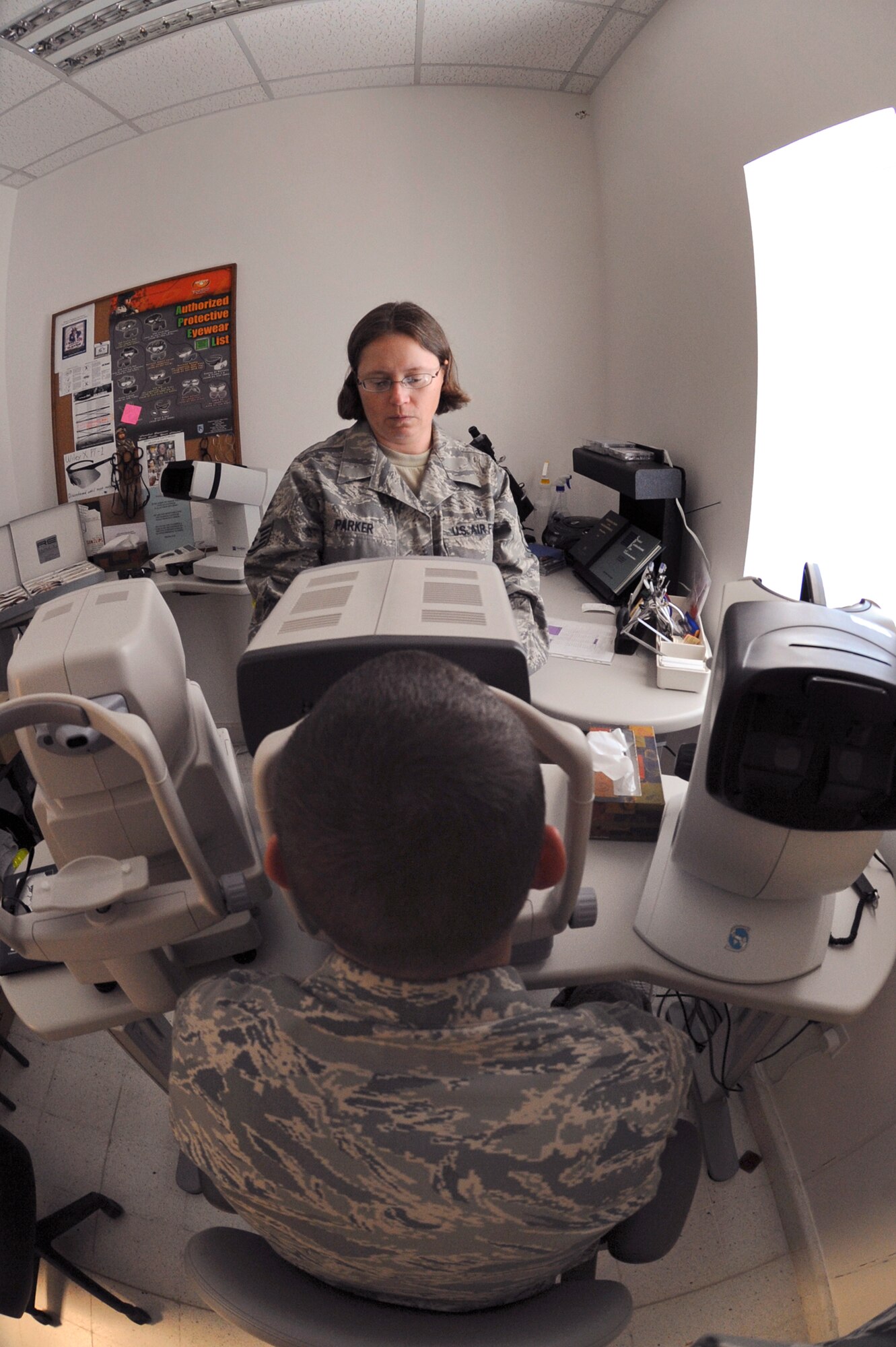 Staff Sgt. Cherie Parker, an ophthalmic technician with the 379th Expeditionary Medical Group, uses an auto-refractor on a patient here in the eye clinic, May 28, 2009, in an undisclosed location in Southwest Asia.  The auto-refractor is used to help Sergeant Parker determine the approximate prescription for each eye of the patient as a starting point for the exam. Sergeant Parker is native to Washington, Ind. and deployed from Wright-Patterson Air Force Base, Ohio, in support of Operations Iraqi and Enduring Freedom and Combined Joint Task Force - Horn of Africa.  (U.S. Air Force Photo by Staff Sgt. Joshua Garcia/released)