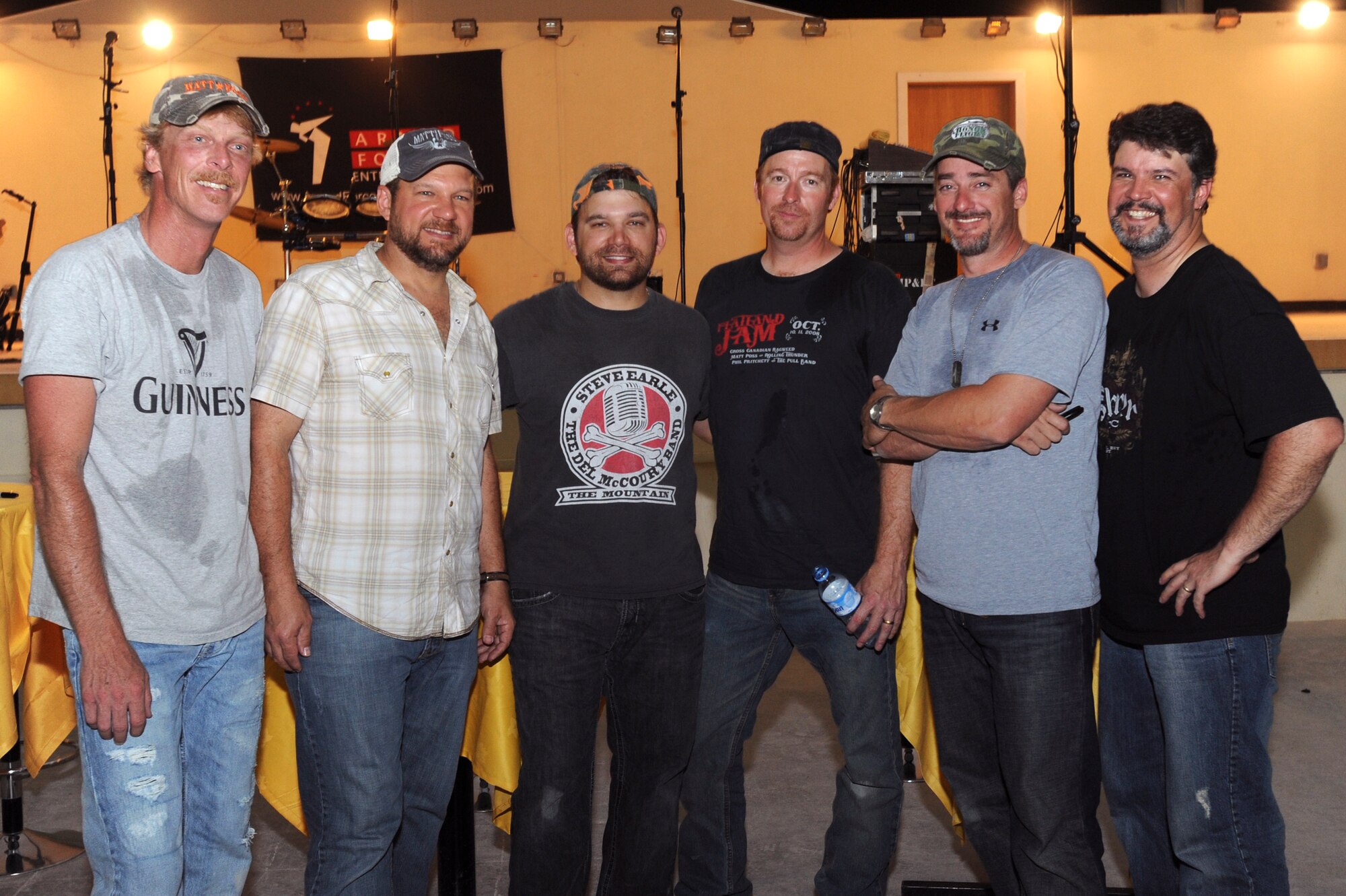 Matt Poss and Rolling Thunder, pose for a photo after their concert for servicemembers here, May 27, 2009, in an undisclosed location in Southwest Asia. The band played original music as well as covers of major artists during the Armed Forces Entertainment tour to multiple bases within the U.S. Central Command's area of responsibility.  (U.S. Air Force photo by Staff Sgt. Joshua Garcia/released)