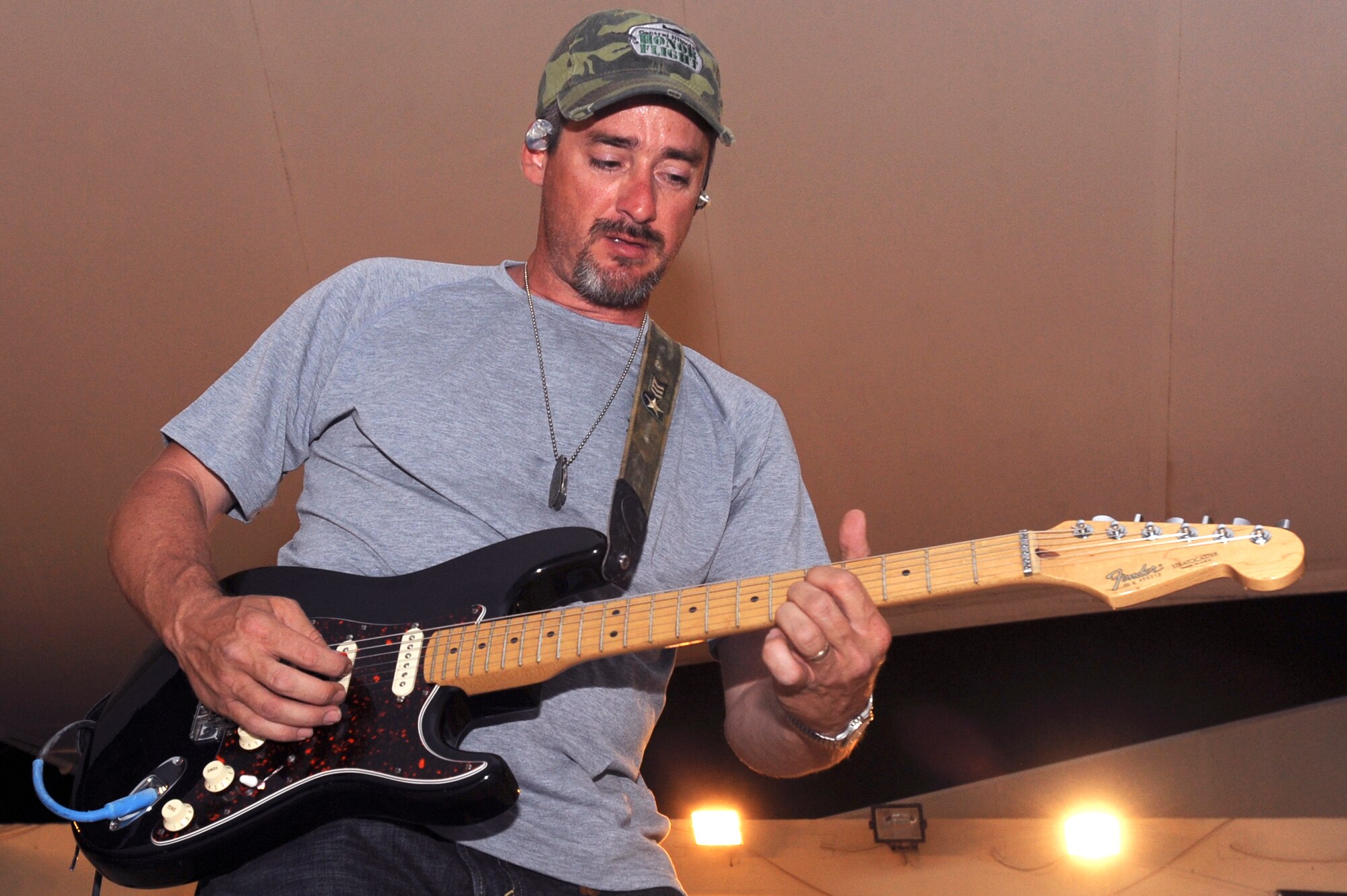Mike McDevitt, the lead guitarist for Matt Poss and Rolling Thunder, plays an electric guitar solo during a concert the band put on for servicemembers here, May 27, 2009, in an undisclosed location in Southwest Asia.  The band played original music as well as covers of major artists during the Armed Forces Entertainment tour to multiple bases within the U.S. Central Command's area of responsibility.  (U.S. Air Force photo by Staff Sgt. Joshua Garcia/released)