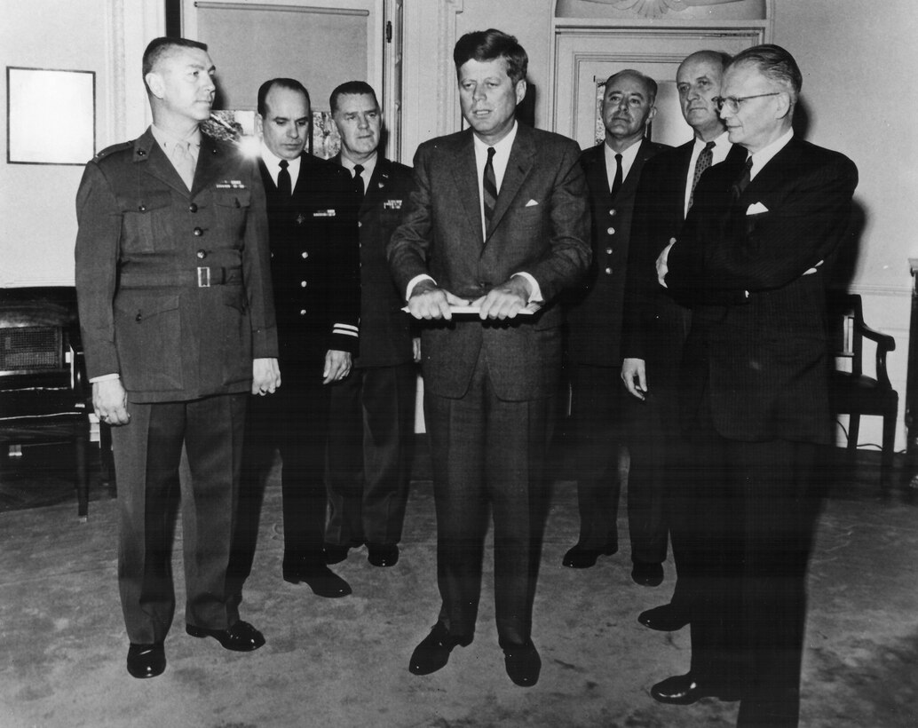 President John F. Kennedy with the service band commanders, including The USAF Band Commander/Conductor Captain Harry Meuser looking at an RCA LP.  Taken April 23, 1963 in the White House.  This is Photo 18.  (Photographer Unknown)
