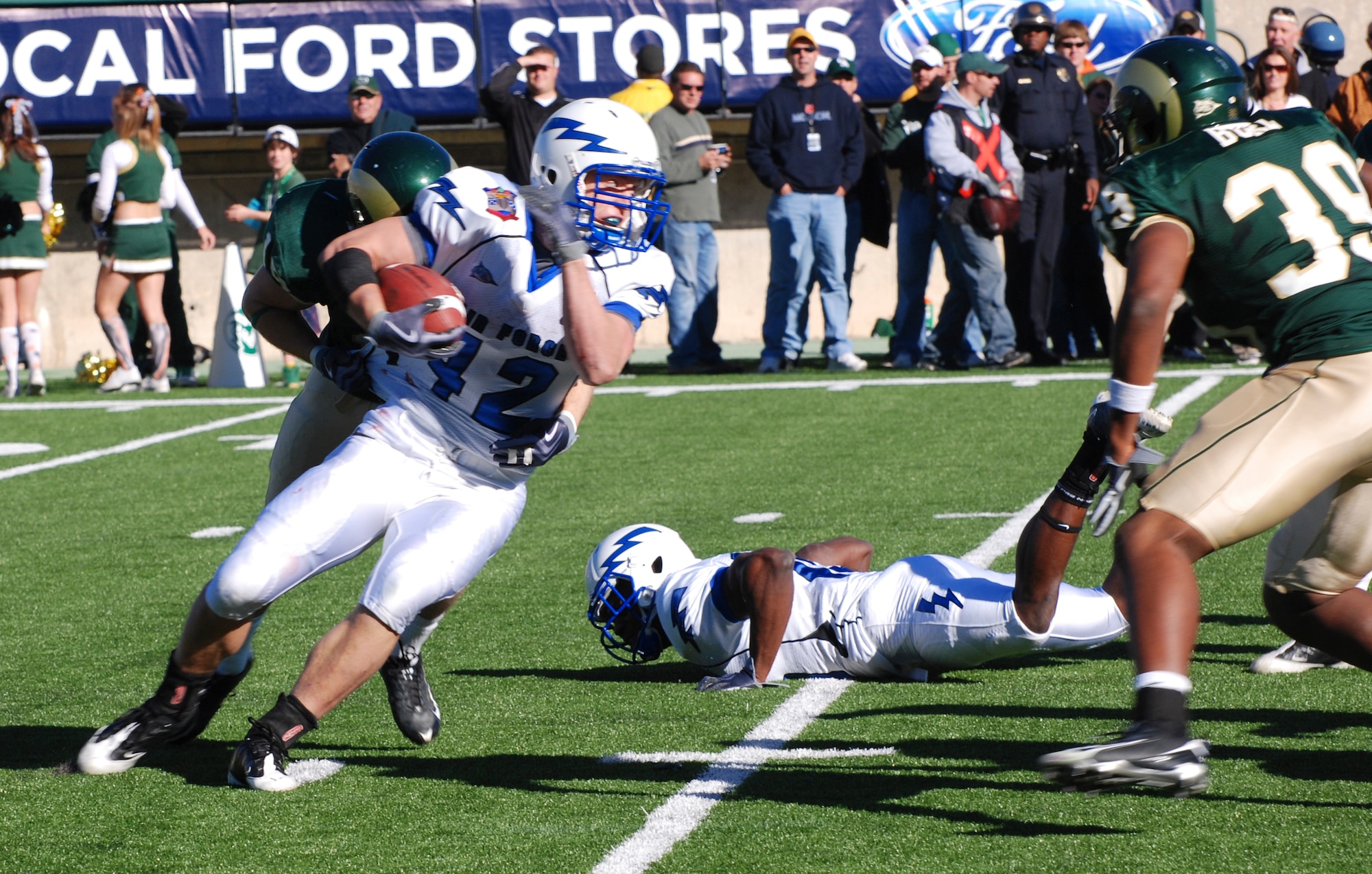 Falcons fullback Jared Tew looks to turn upfield as a Colorado State University defender tries to wrap him up during the Air Force-Colorado State match in Fort Collins, Colo., Oct. 31, 2009. The fullback had 145 all-purpose yards against CSU, including 58 yards on kick returns. (U.S. Air Force photo/Denise Navoy)