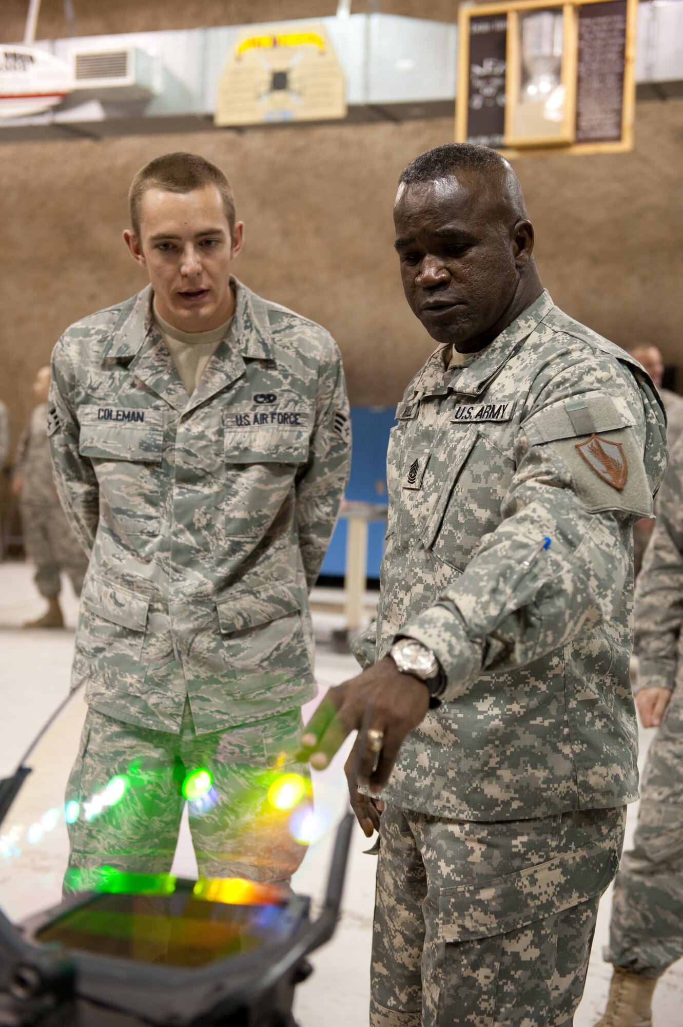SOUTHWEST ASIA - Command Sergeant Major Marvin Hill, command senior enlisted leader of U.S. Central Command, is shown an F-15 heads-up display that is typical of what is worked on by Senior Airman Shea Coleman from the 379th Expeditionary Maintenance Squadron, Oct. 28, 2009, in Southwest Asia. Command Sergeant Major Hill toured 379 AEW facilities as part of a U.S. CENTCOM trip throughout Southwest Asia. (U.S. Air Force photo/Staff Sgt. Robert Barney) 