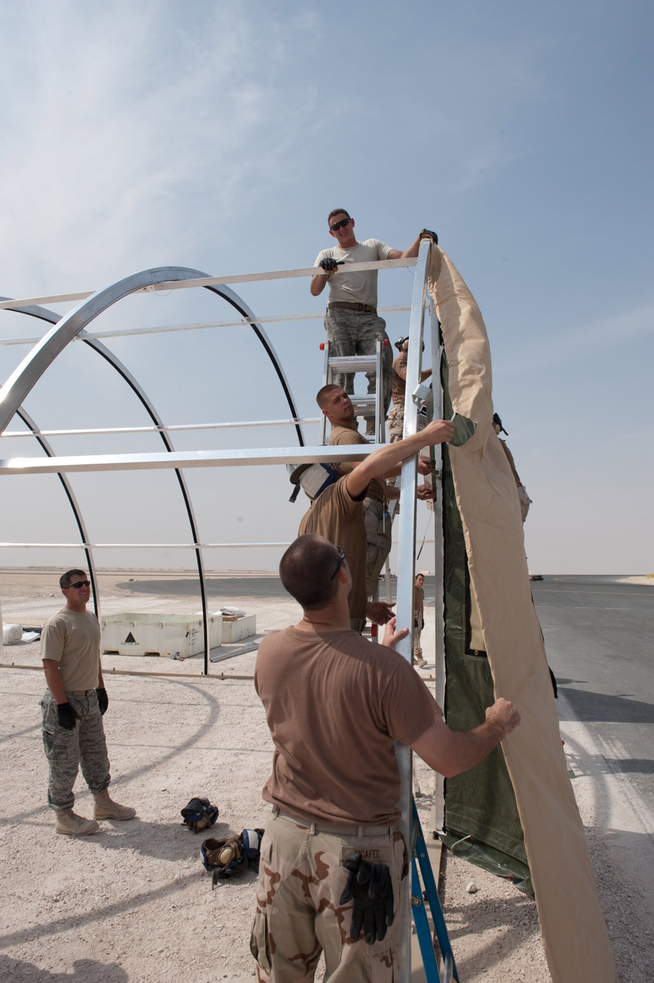 U.S. Navy Sailors from Patrol Squadron 10 and Airmen assemble a tent for Navy maintenance operations, which are are relocating from another location on base, Oct. 23, 2009, in Southwest Asia. The VP-10 squadron maintains and operates the P-3 Orion, a land-based, long-range, anti-submarine warfare patrol aircraft that performs regular missions in support of Operation Enduring Freedom.  (U.S. Air Force photo/Staff Sgt. Robert Barney) 