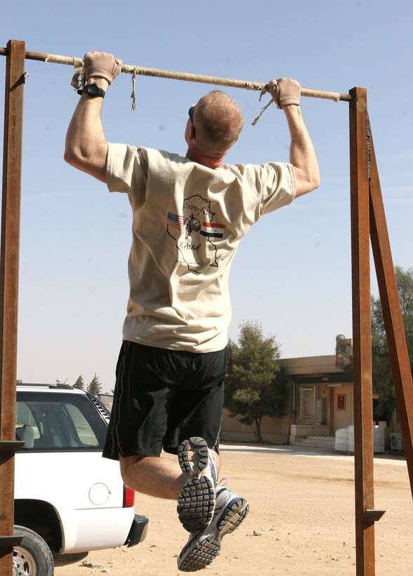 Master Sgt. Richard Buer, base telephone chief, executes pull-ups during a CrossFit session aboard Al Asad Air Base, Iraq, Nov. 6, 2009. CrossFit combines three different methods of training: cardio, gymnastics and weight lifting, to allow people of all skill levels to participate and work to achieve their training goals.