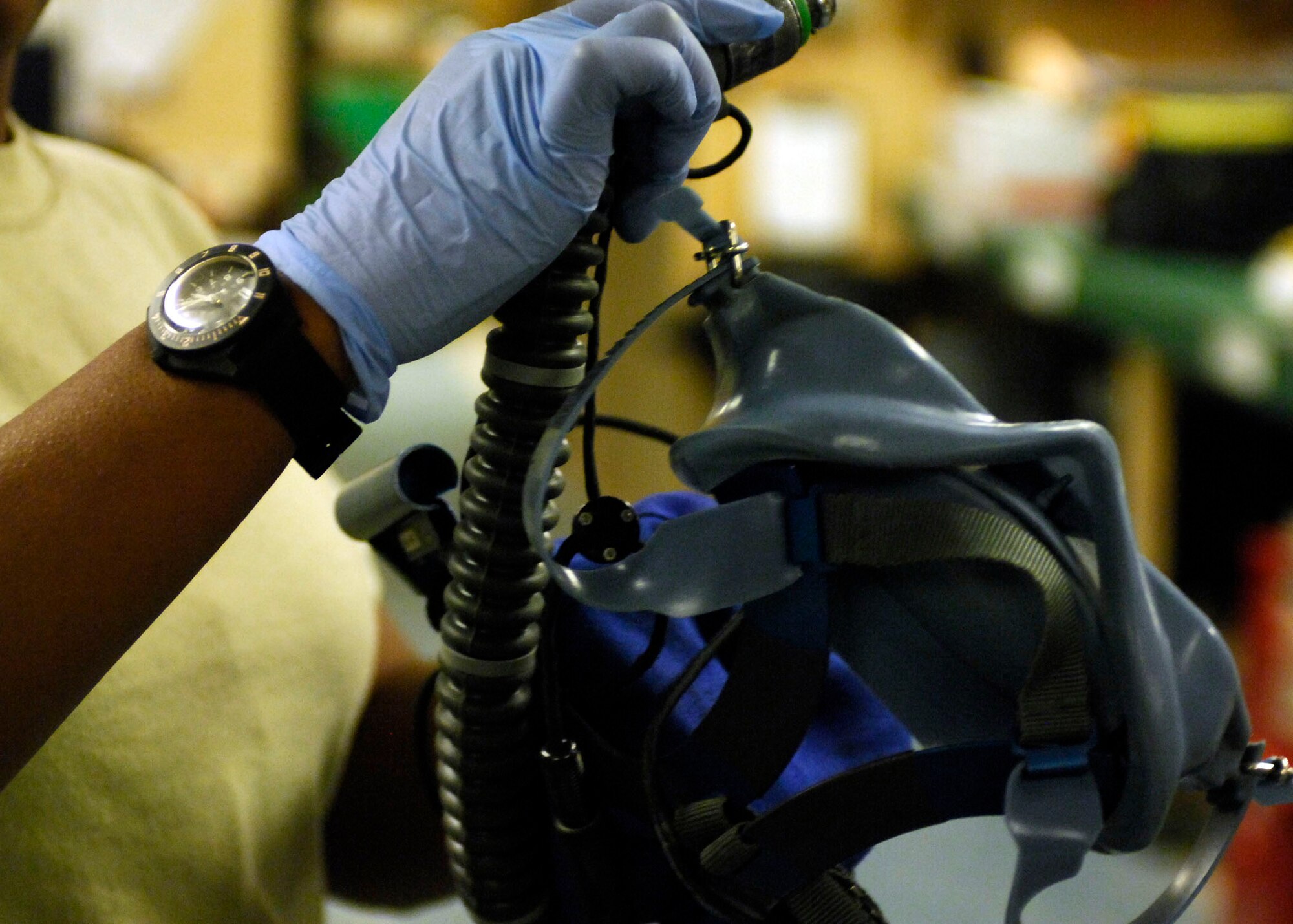 BAGRAM AIRFIELD, Afghanistan -- Senior Airman Charlene Grant, an aircrew flight equipment Airman from the 445th Expeditionary Operation Support Squadron, inspects an oxygen mask Nov. 2, 2009. Inspections are done to assure there are no cracks or other damage.   Airman Grant is deployed from Tinker Air Force Base, Okla., and hails from Chicago.  (U.S. Air Force photo/Senior Airman Felicia Juenke)