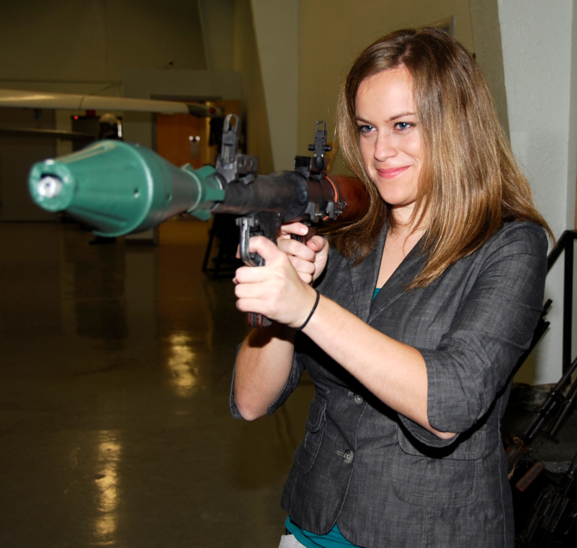 Kelsie Moger, KFTA Fox 24 reporter, handles a nonfunctioning Russian anti-aircraft weapon during a guided tour of the 547th Intelligence Squadron's Threat Systems Area, informally dubbed "The Petting Zoo," at Nellis Air Force Base, Nev., Oct. 15 during a civic tour to the base. The primary objective was to observe the 188th's deployment preparations for the unit's upcoming Aerospace Expeditionary Force (AEF) rotation in Afghanistan in spring 2010. (U.S. Air Force photo by Senior Master Sgt. Dennis Brambl/188th Fighter Wing Public Affairs) 