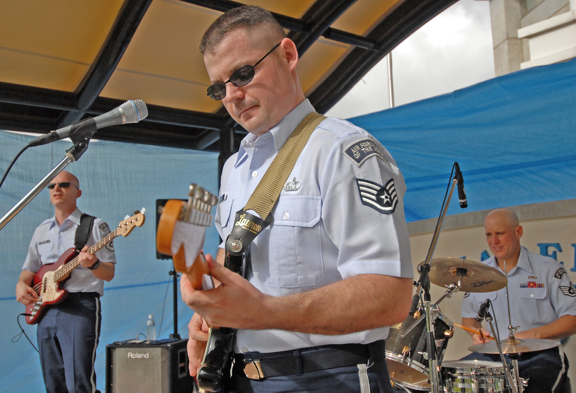 From left to right, Master Sgt. Jon Packard, Staff Sgt. Dan Bragdon and Staff Sgt. Chuck Lawyer from Pacific Air Forces’ “Final Approach” band perform during the first day of the Kadena Circle Festival Oct. 31. The band from Yokota Air Base, Japan, performed a variety of music during the two-day festival near Kadena’s Gate 4. (Air Force/Staff Sgt. Jason Lake)
