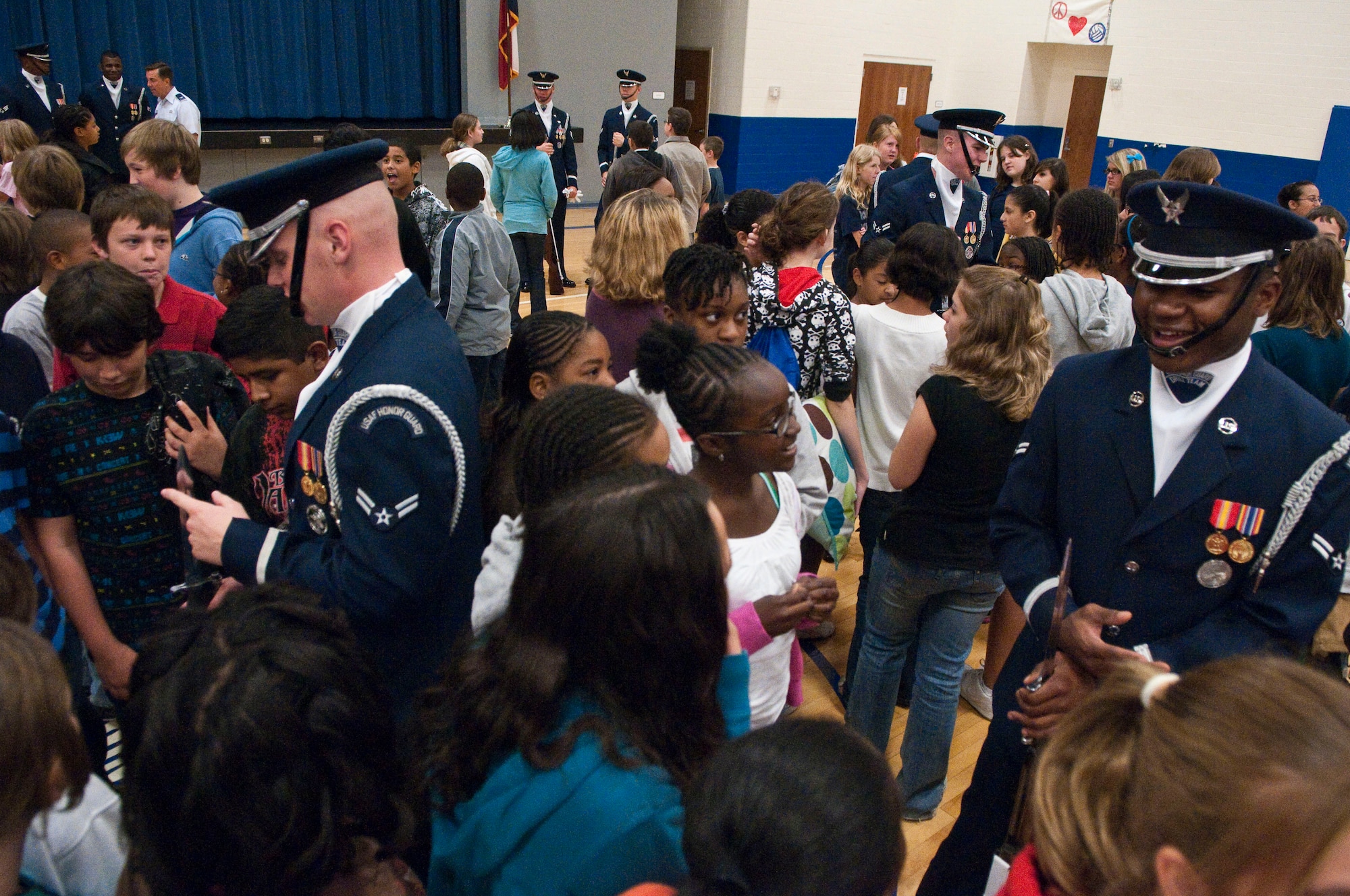 Air Force Drill Team members, Airman 1st Class Doyle Boyd (left) and Airman 1st Class Andrew Winders answer questions for middle school students at Randolph Independent School District  after a performance of Air Force precision and professionalism for the Ro-Hawks of Randolph High School Nov. 2. (U.S. Air Force photo/Steve Thurow)