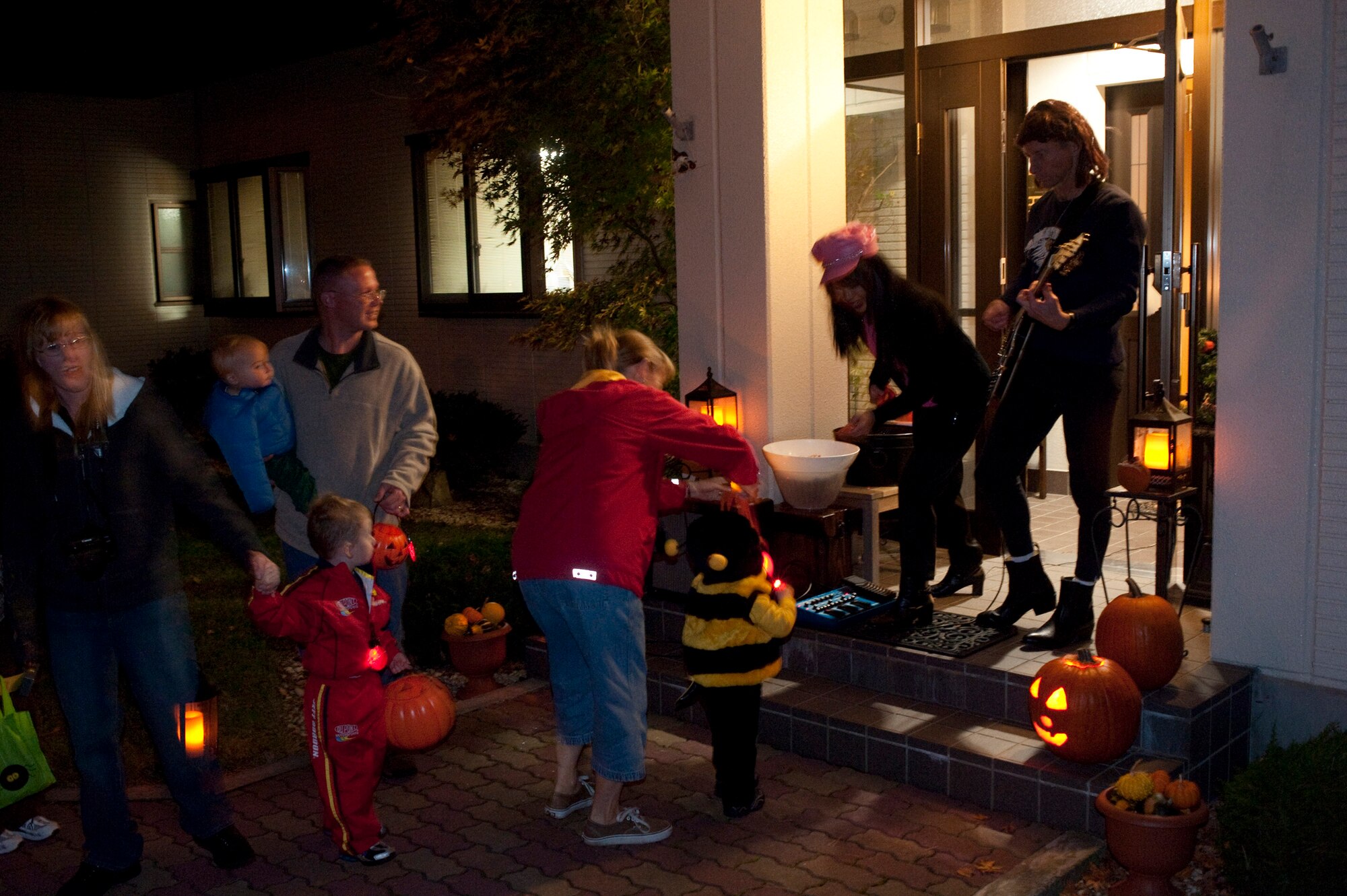 MISAWA AIR BASE, Japan -- Col. David Stilwell, 35th Fighter Wing commander, and his wife, Jan, hand out candy at their house on Halloween. An estimated 600 Japanese trick-or-treaters joined the children on base for the annual festivities. (U.S. Air Force photo/Staff Sgt. Samuel Morse)