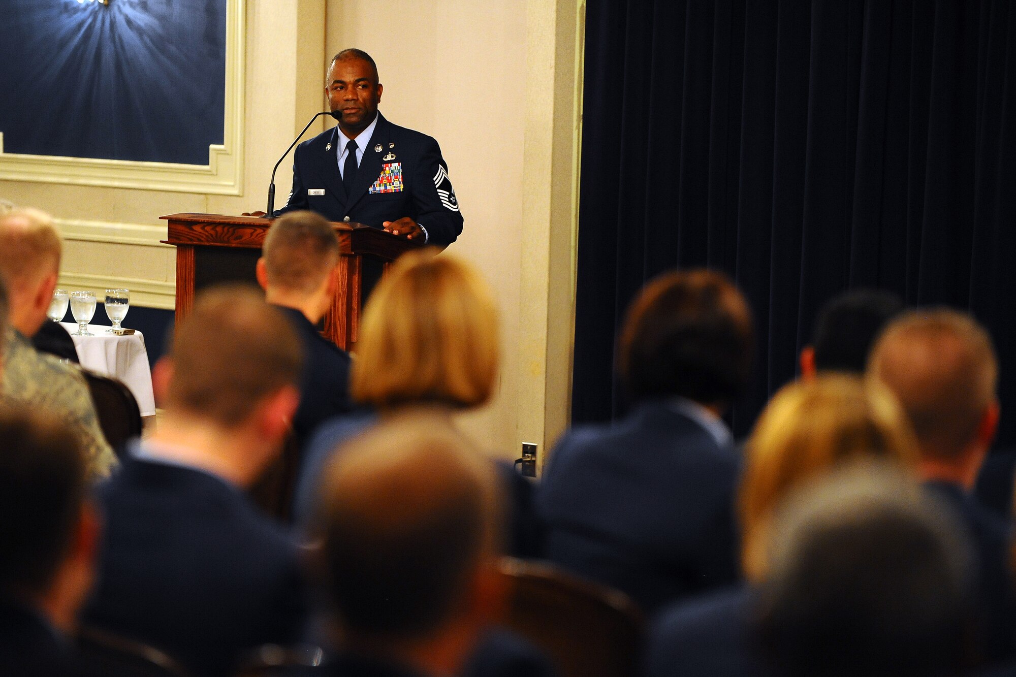 OFFUTT AIR FORCE BASE - Chief Master Sgt. Gary B. Carter, Superintendent for the 1st Weather Group of the Air Force Weather Agency, delivers the commencement address during Offutt's 2009 Fall Community College of the Air Force graduation ceremony at the Patriot Club here Oct. 30. During the ceremony 47 Airmen received their CCAF degrees. U.S. Air Force Photo by Josh Plueger
