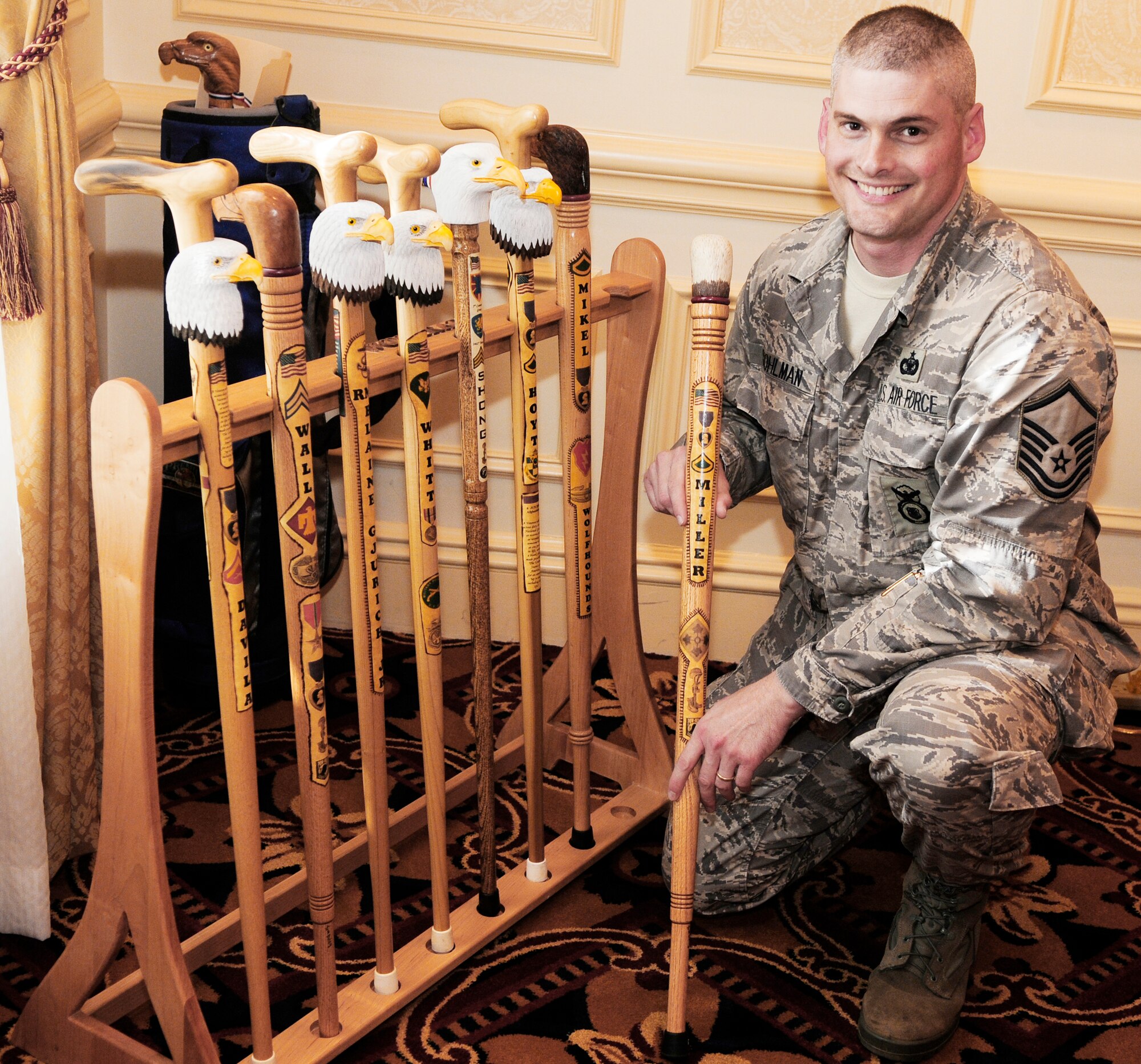 Master Sgt. Bruce Stohlman Jr. shows several finished eagle head canes Oct. 7, 2009, at the Walter Reed Medical Center in Washington, D.C. Sergeant Stohlman volunteers his woodworking skills hand-carving canes for wounded veterans with the Northern Virginia Woodcarvers as part of the Eagle Cane Project. The Eagle Cane Project is an off-shoot of Soldiers' Angels, a nonprofit organization providing aid and comfort to United States servicemembers and their families. Sergeant Stohlman is the Bolling Air Force Base Joint Visitors' Center superintendent in Washington, D.C. (U.S. Air Force photo/Airman 1st Class Susan Moreno)