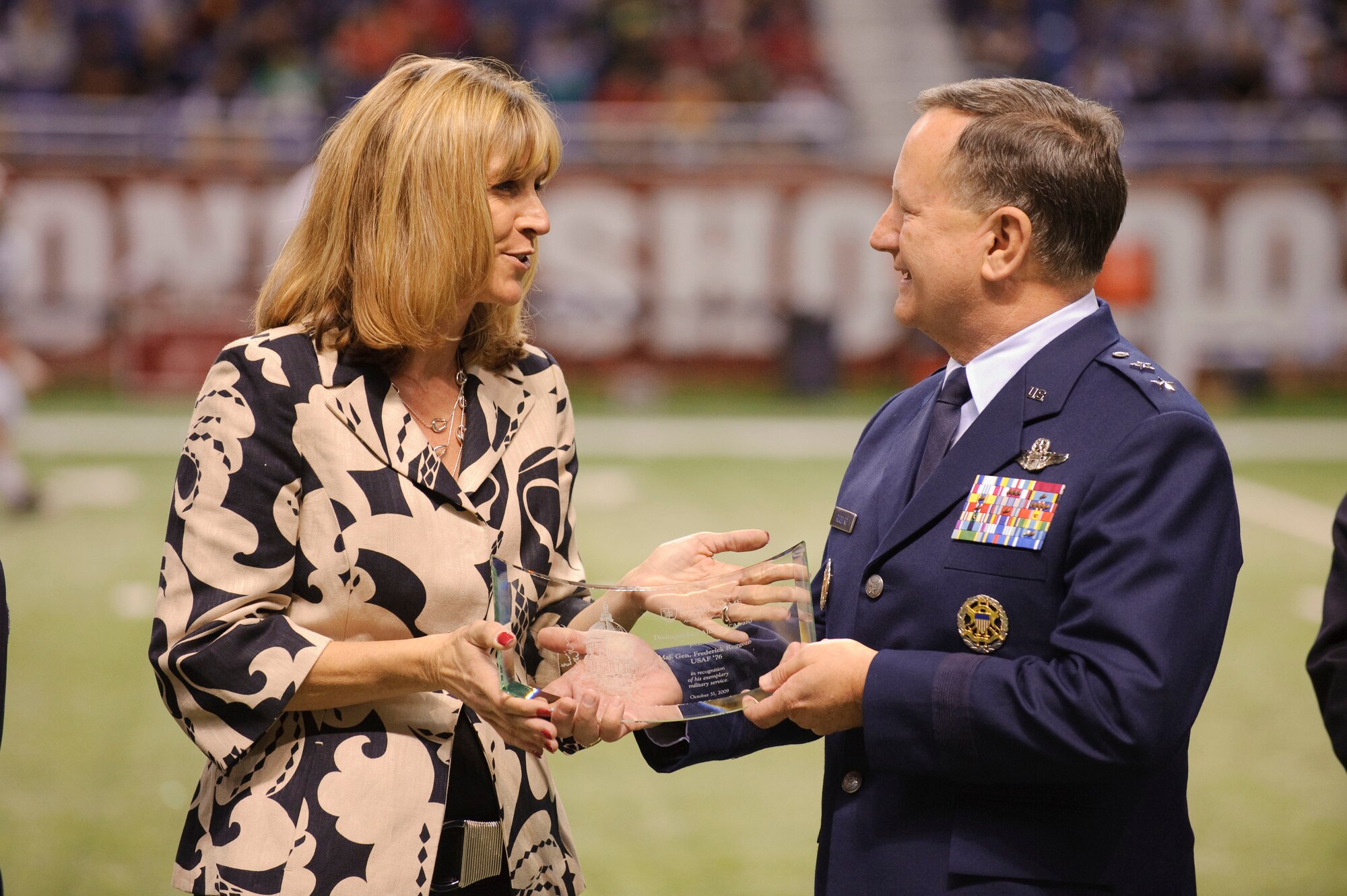 Holly Colman, president of the Notre Dame alumni association, presents Maj. Gen. Fred Roggero Air Force chief of safety with the Distinguished Alumnus Award which is presented in recognition of exemplary service to Notre Dame or community. General Roggero earned a bachelor of arts degree in government from the University of Notre Dame in 1976. (U.S. Air Force photo/Steve Thurow)