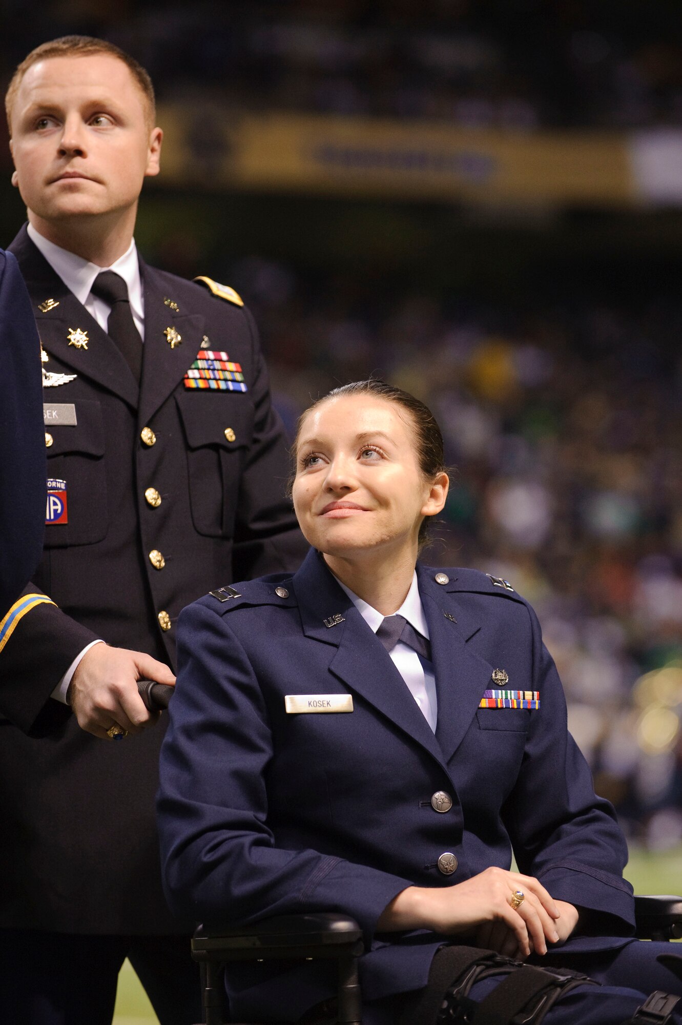 Army Capt. Joe Kosek, assistant professor of Army Science for the Notre Dame Army ROTC program and his sister Air Force Capt. Wendy Kosek were among alumni recognized during a ceremony at half-time of the Notre Dame, Washington State football game held at the Alamodome in San Antonio, Texas. Capt. Wendy Kosek is currently recovering from injuries sustained while deployed, and holds a bachelor's and law degree from Notre Dame University. (U.S. Air Force by Steve Thurow)