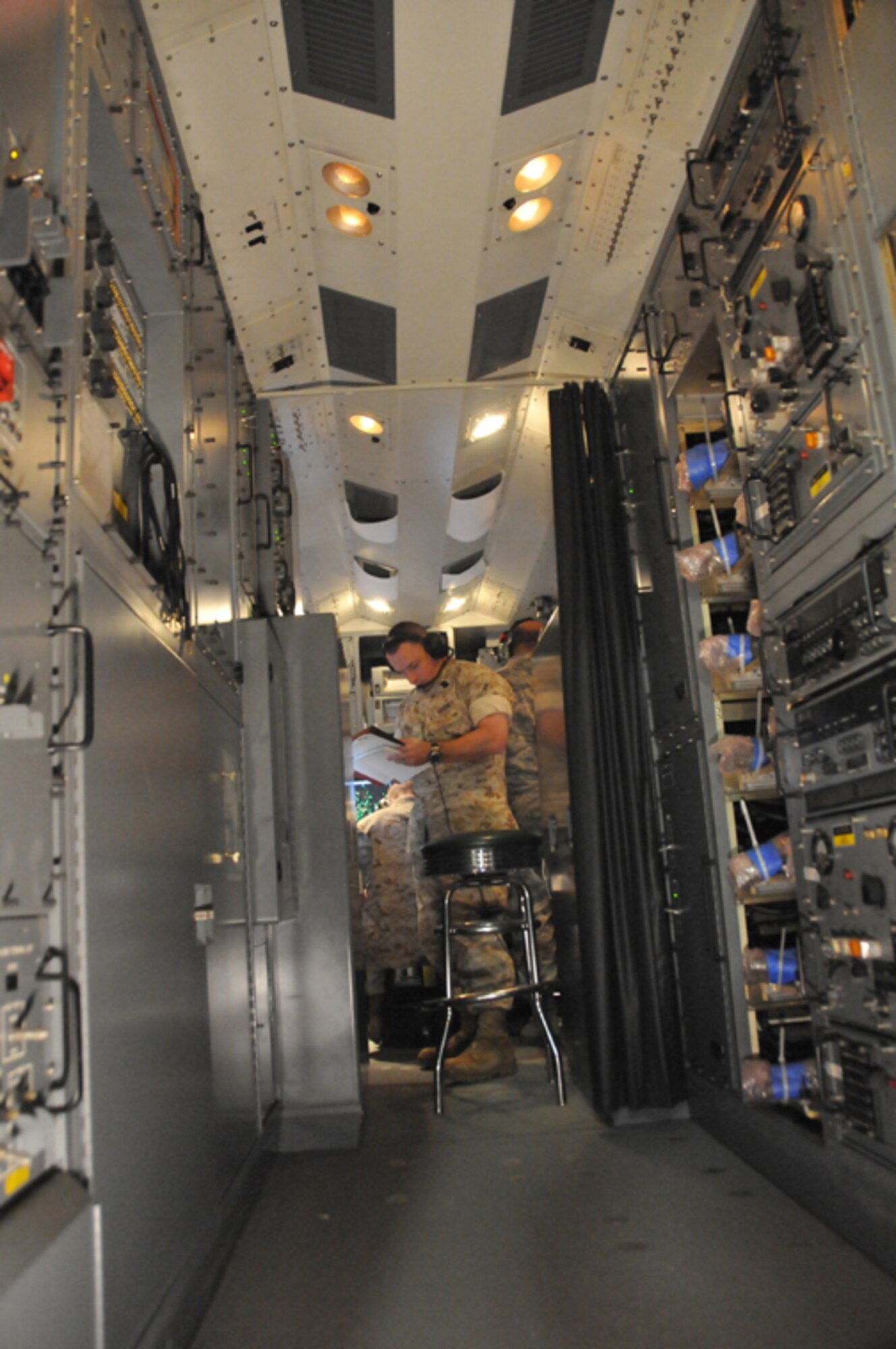 KIRTLAND AIR FORCE BASE, N.M. -- U.S. Marines work alongside Airmen in the Control Reporting Center at the Distributed Mission Operations Center on Sept. 23. This CRC is an actual module that could be used in today's fight. 
The CRC integrates information from multiple data links from air-, sea-, and land-based sensors, as well as from its surveillance and control radars. (Air Force photo by Ken Moore)