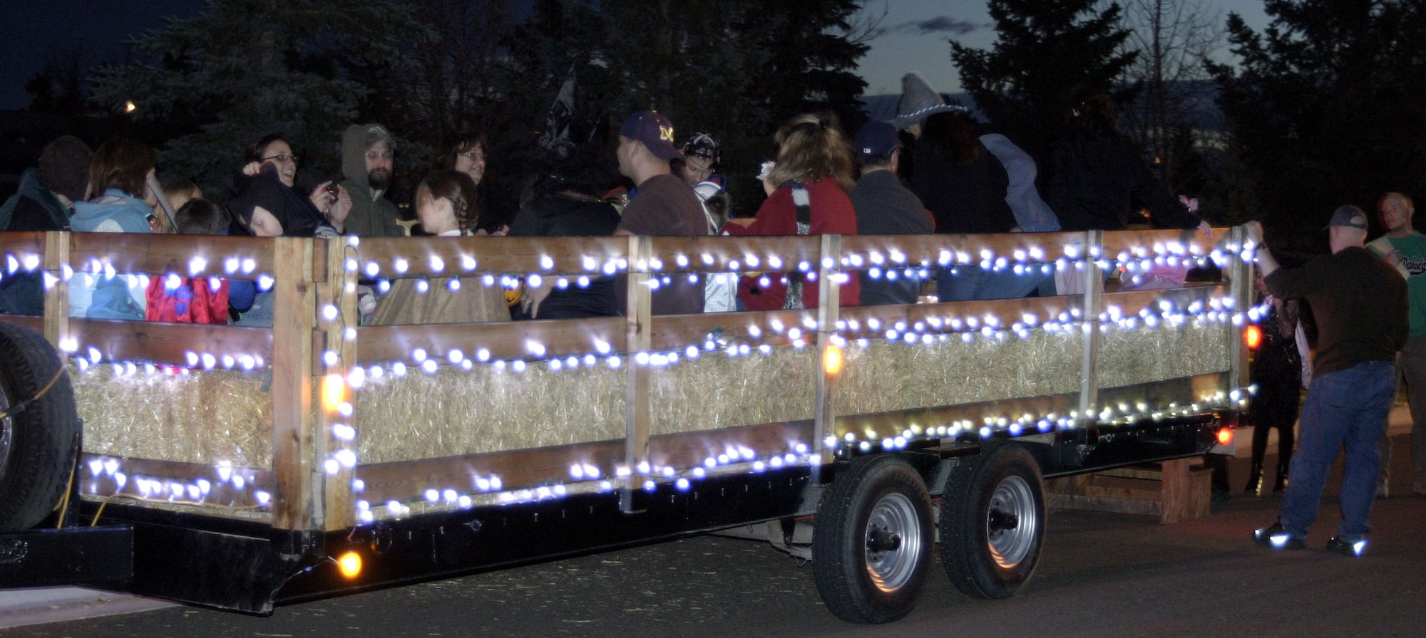 Team Malmstrom members enjoy a hayride through housing, which made a special stop at the wing commander's house, Oct. 31. (U.S. Air Force photo/Senior Airman Dillon White)