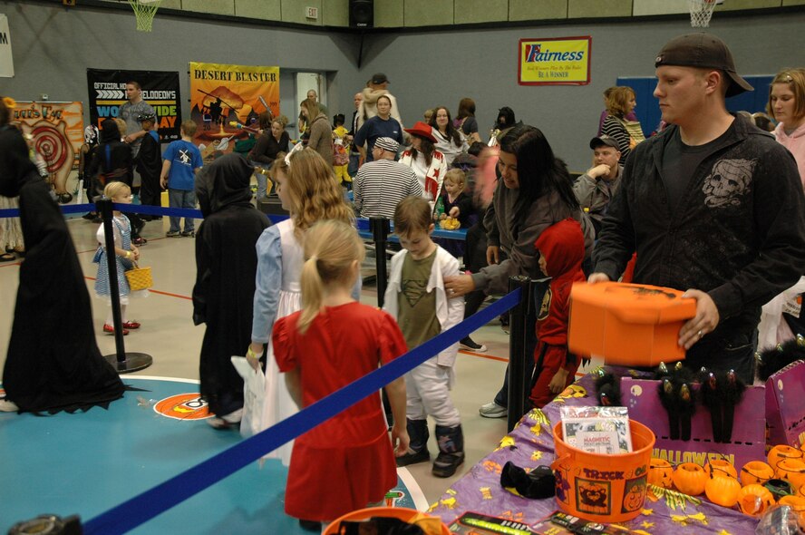 Senior Airman Jason Daniels, 341st Security Forces Group Tactical Response Force member, mans the musical pumpkins game at the Youth Center's Fall Festival Oct. 30. (U.S. Air Force photo/Senior Airman Dillon White)