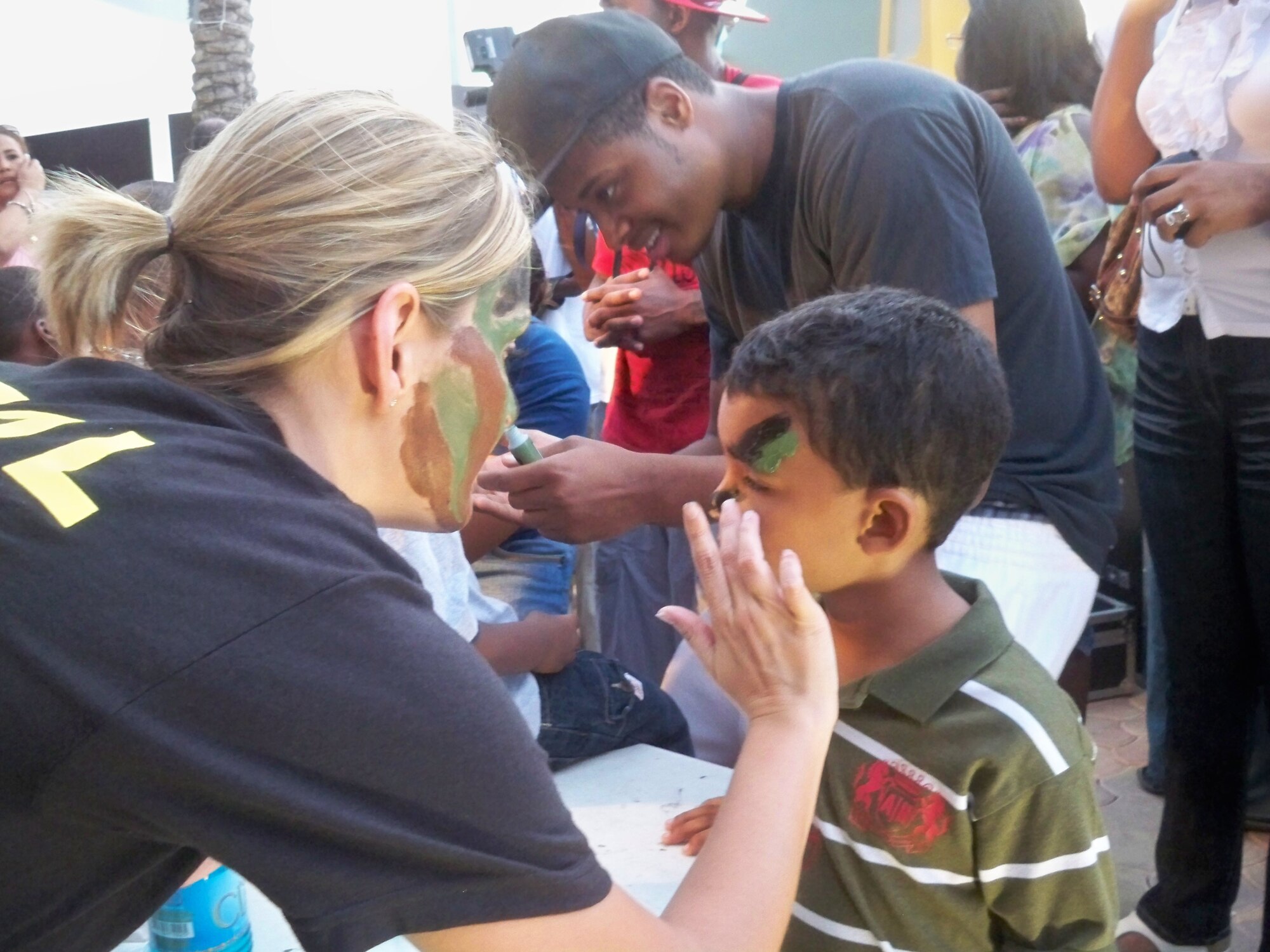 Staff Sgt. Erica Spencer and Airman First Class Wilderico Sibert, both members of the 964 AACS, enjoyed interacting with the local children during their deployment to Curacao in support of counter-drug operations. US Air Force Photo / Senior Airman Joseph Dunk.