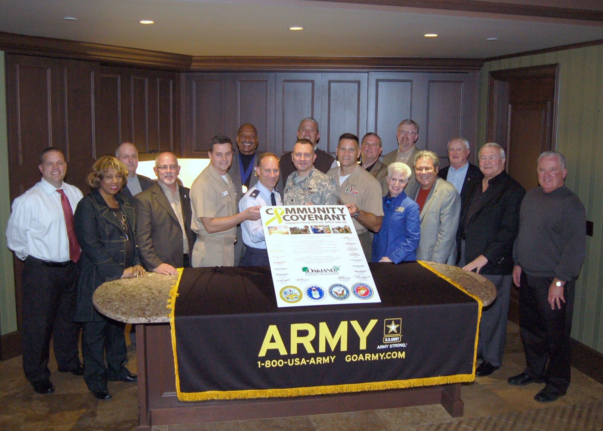 Lt. Col. Todd Weyerstrass, 339th Recruiting Squadron commander (center), Oakland County officials and representatives from the Armed Services signed Michigan’s first Military Community Covenant at The Palace of Auburn Hills in Auburn Hills, Mich. The community covenant is an Army program, but it extends to the other military services, recognizing that many community efforts support all servicemembers and their families regardless of the uniform they wear.  (Photo courtesy of Great Lakes Recruiting Battalion)