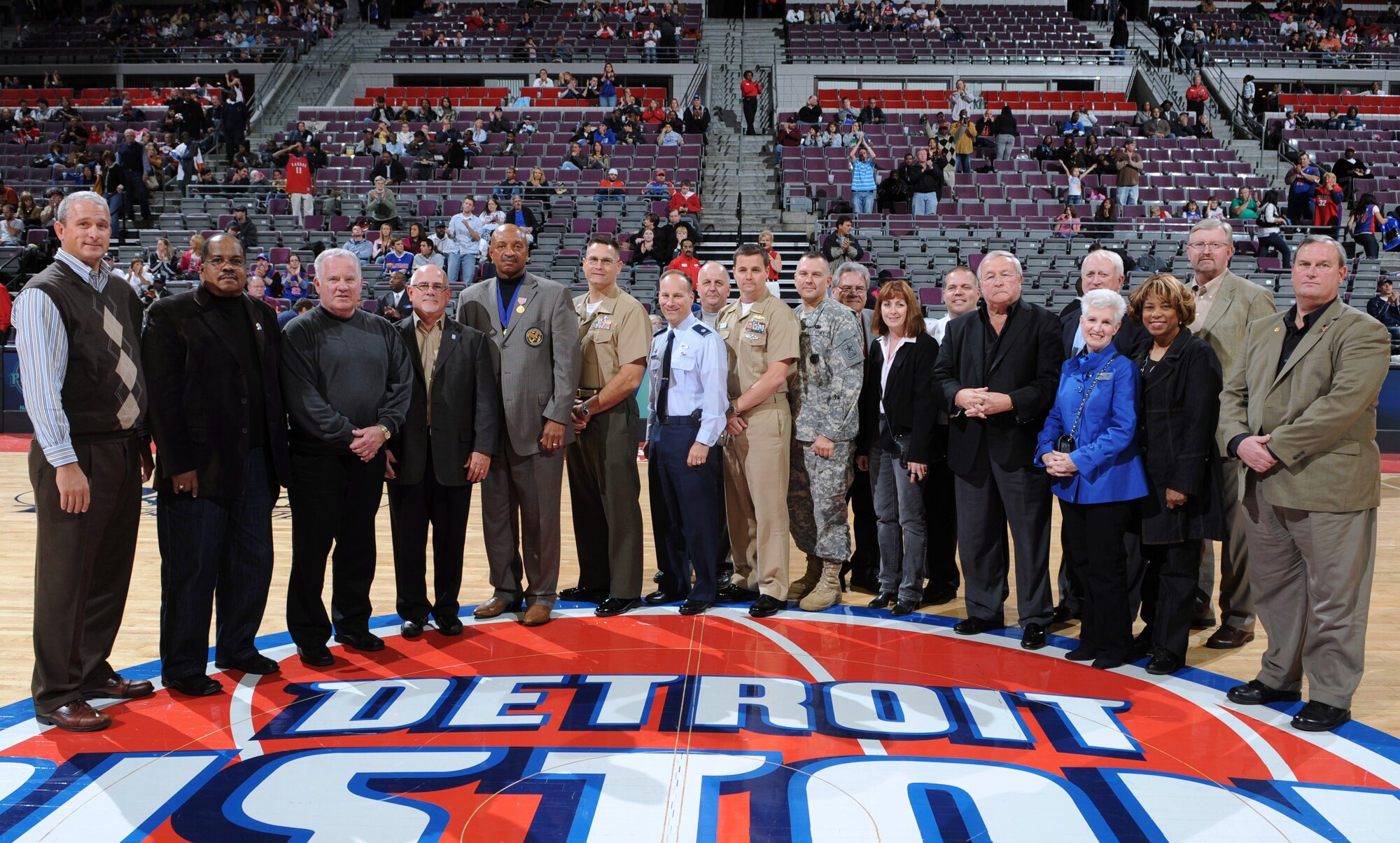 Lt. Col. Todd Weyerstrass, 339th Recruiting Squadron commander (center), Oakland County officials and representatives from the Armed Services meet during halftime at the Detroit Pistons basketball game Oct. 11, prior to signing Michigan’s first Military Community Covenant.  The community covenant is an Army program, but it extends to the other military services, recognizing that many community efforts support all servicemembers and their families regardless of the uniform they wear.  (Courtesy photo of Great Lakes Recruiting Battalion)
