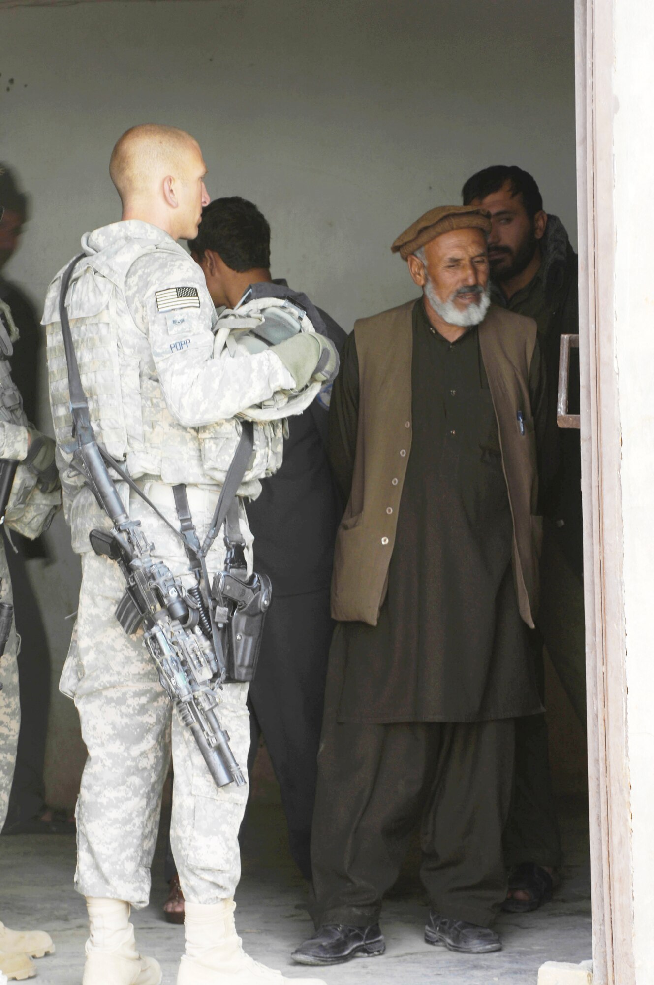 Staff Sgt. David Popp meets with Afghan prison officials during a mentoring session Oct. 28, 2009, in Qalat, Afghanistan. Sergeant Popp, a security forces Airman assigned to the Zabul Provincial Reconstruction Team, is deployed to the region from Creech Air Force Base, Nev. He works with the guards, helping them become better at handling prisoners within the compound. The mission is just one of many the PRT takes on, which can range from foot patrols to working with government officials. (U.S. Air Force photo/Tech. Sgt. Joseph Kapinos) 