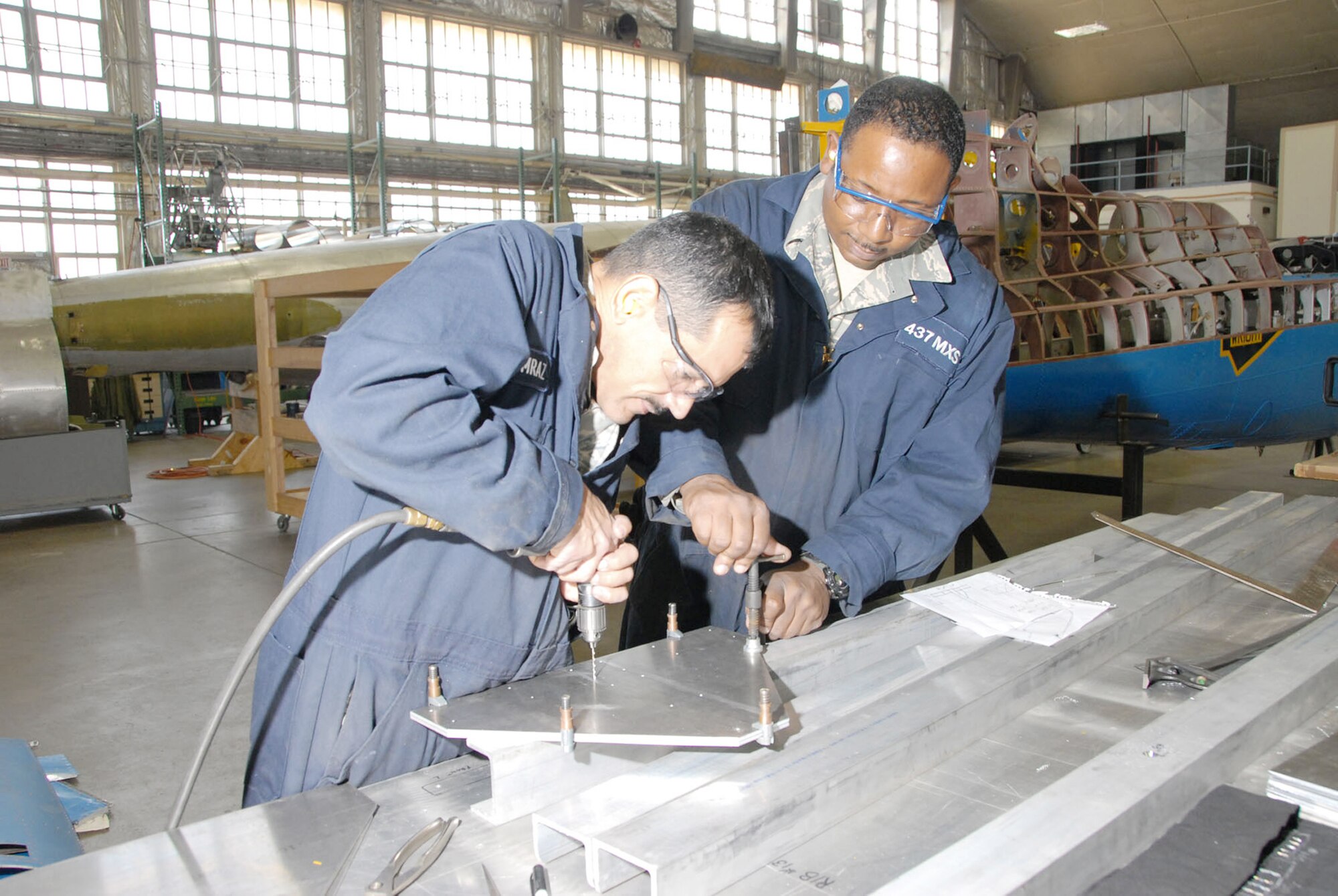 Reservists with the 315th Maintenance Squadron from Charleston Air Force Base, S.C., work on a stand for the B-17F Memphis Belle's wing during a two-week stay at Wright-Patterson Air Force Base, Ohio, where the group worked in the restoration hangar at the National Museum of the U.S. Air Force in nearby Dayton. (U.S. Air Force photo)