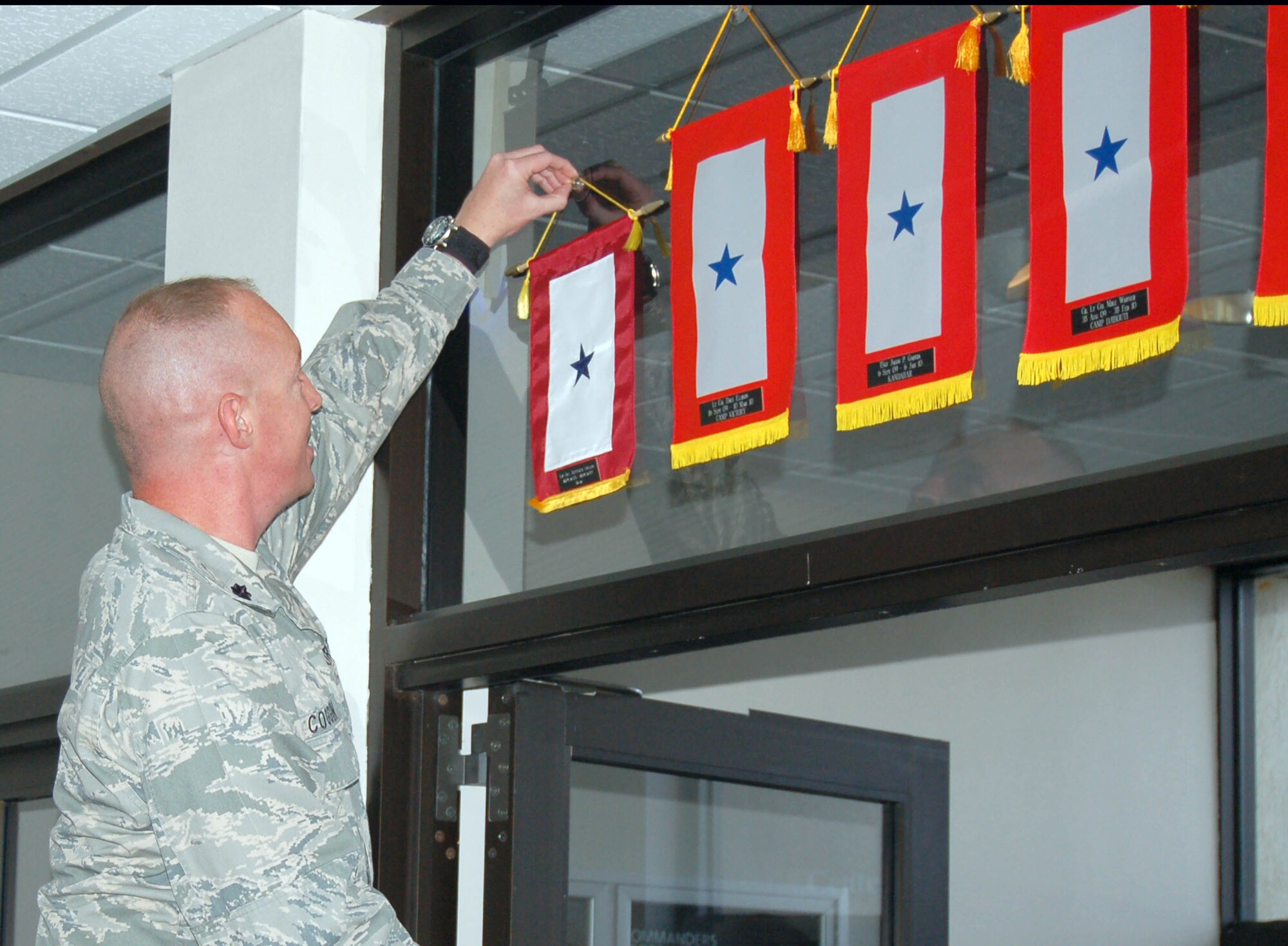 Lt. Col. Jeffrey H. Coggin, an instructor at the Eaker Center for Professional Development's Defense Financial Management and Comptroller School, 'retires' his deployment flag during a ceremony Oct. 27 here. Colonel Coggin recently returned from a deployment as the Multi-National Corps-Iraq deputy comptroller where he taught a modified version of the Defense Decision Support Course to Iraqi and American staff officers. The DDSC is currently taught at the DFM&CS here. In 2008, Eaker Center more than 4,500 in-residence and 1,700 distance learning students. (U.S. Air Force photo/Capt. Timothy Soehner)
