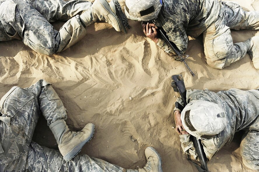 Basic trainees low crawl through a tactical course at the Basic Expeditionary Airman Skills Training course at Lackland Air Force Base, Texas. BEAST replicates the sights, sounds and emotions Airmen will experience in the deployed environment. (U.S. Air Force photo/Senior Airman Christopher Griffin) 