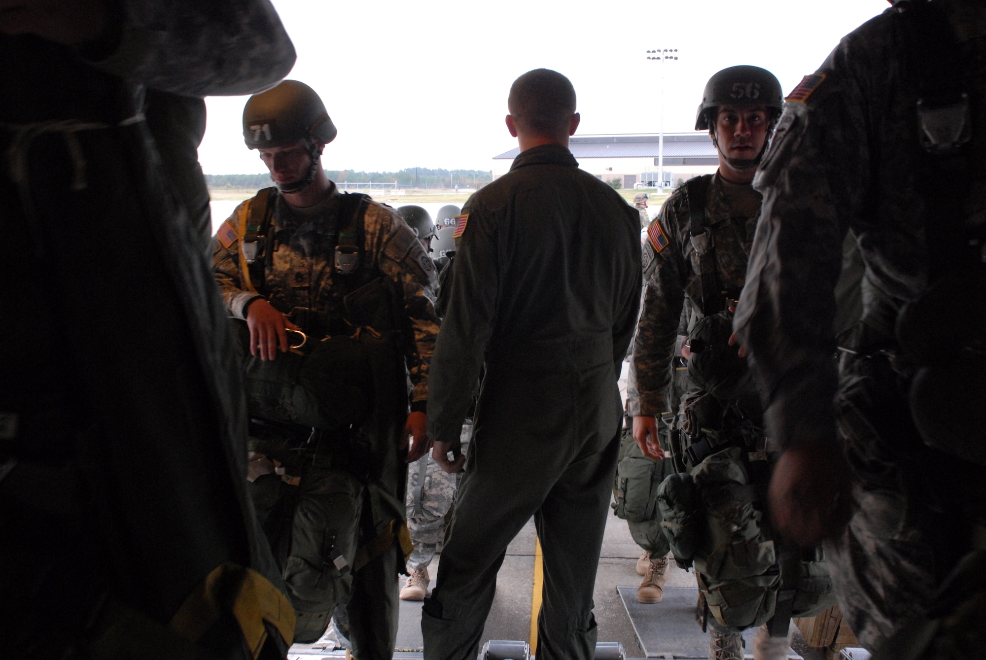Senior Airman Bart Johnson, 50th Airlift Squadron C-130H3 loadmaster from Little Rock Air Force Base, Ark. (center), watches as paratroopers from the U.S. Army Advanced Airborne school load a C-130H3 Oct. 27 as part of a joint force exercise at Pope AFB, N.C. The JFEX focused on cohesive training between the Air Force and Army to reestablish forcible entry capability through air power. (U.S. Air Force photo by Senior Airman Nathan Allen)