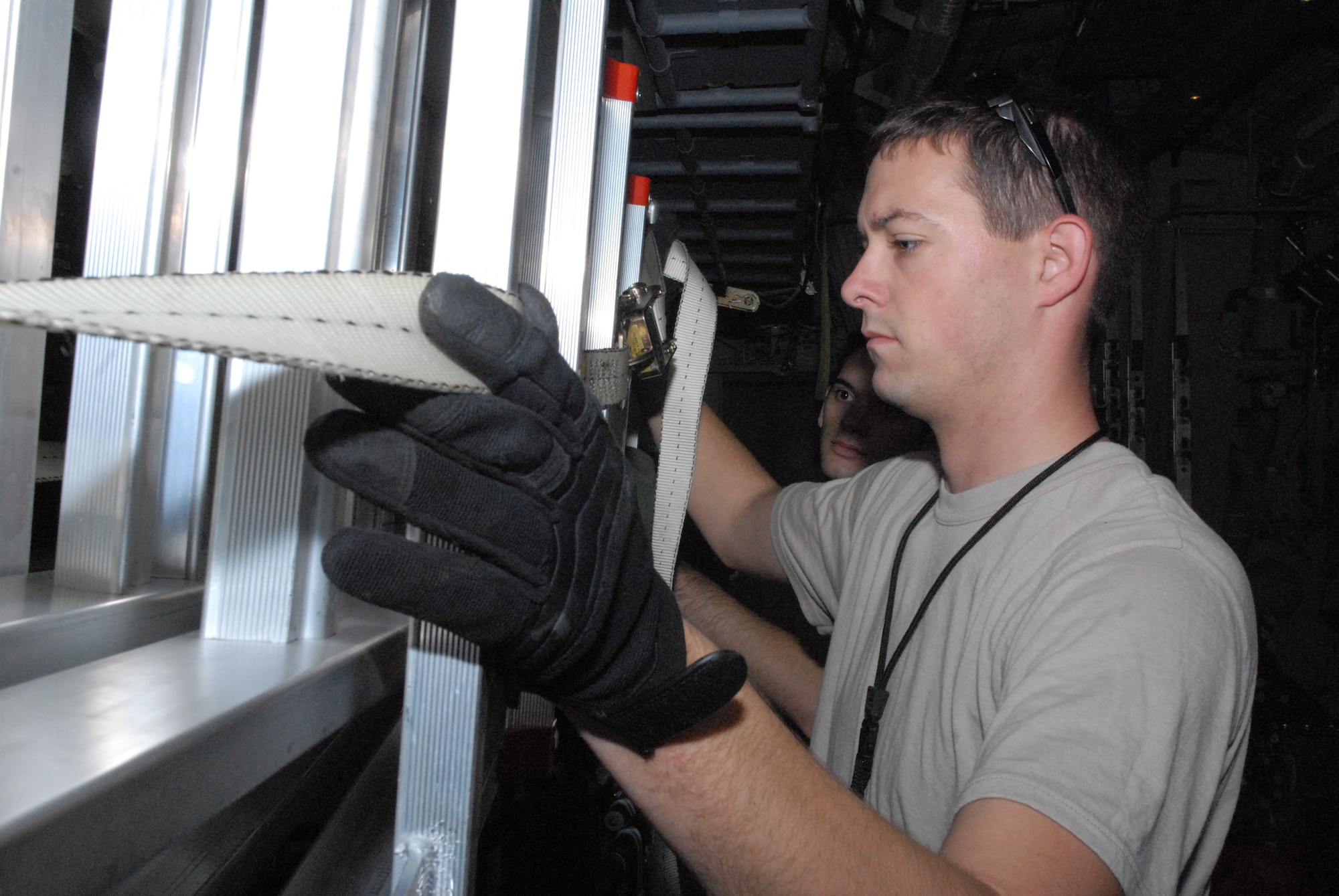 Senior Airman William Heptig, 19th Aircraft Maintenance Squadron crew chief from Little Rock Air Force Base, Ark., stows a ladder during the pre-flight maintenance of a C-130J Oct. 28 as part of a joint force exercise at Pope AFB, N.C. The JFEX focused on cohesive training between the Air Force and Army to reestablish forcible entry capability through air power. (U.S. Air Force photo by Senior Airman Nathan Allen)