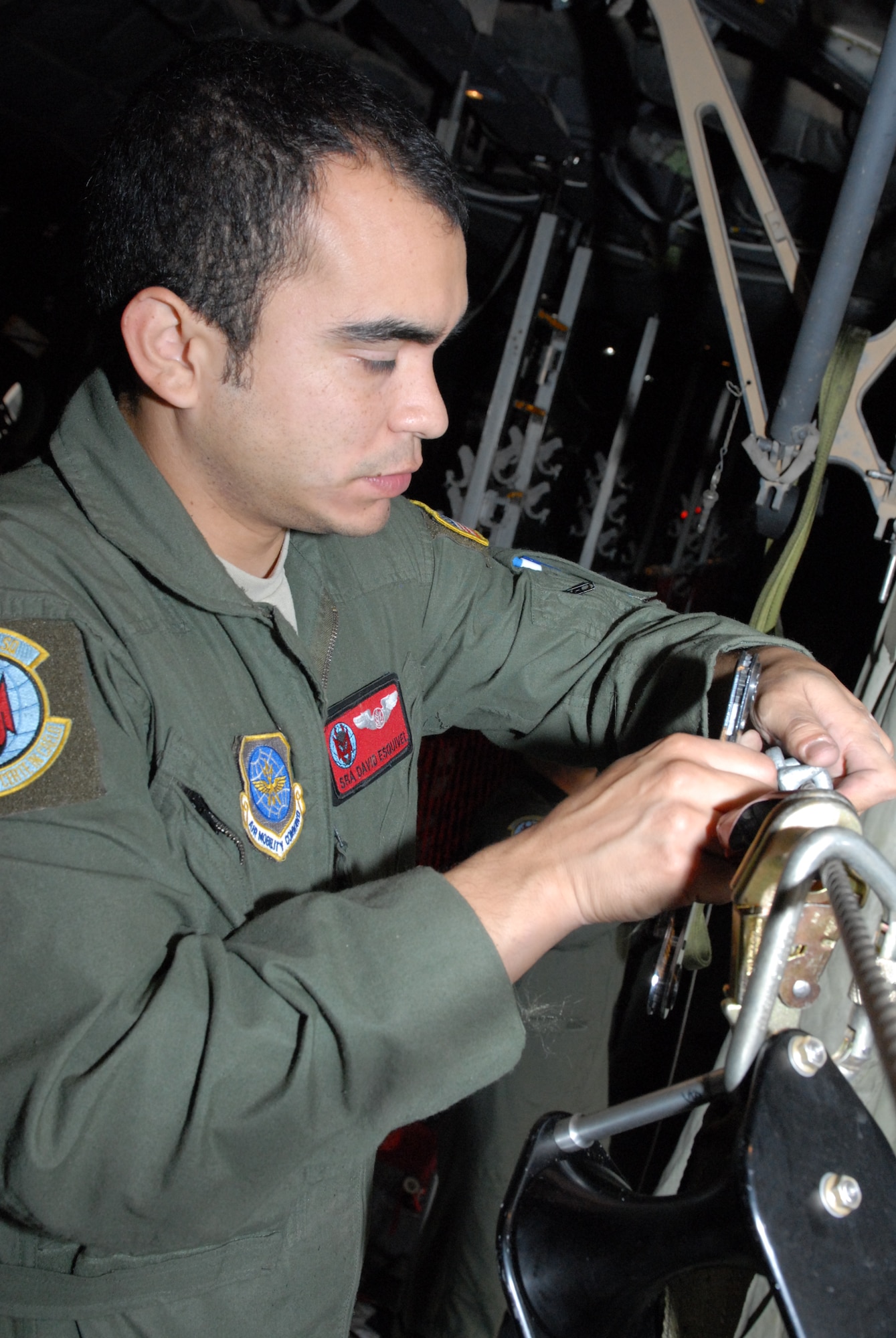 Senior Airman David Esquivel, 50th Airlift Squadron C-130H3 loadmaster from Little Rock Air Force Base, Ark. secures a paratrooper jump cable Oct. 27 as part of a joint force exercise at Pope AFB, N.C. The JFEX focused on cohesive training between the Air Force and Army to reestablish forcible entry capability through air power. (U.S. Air Force photo by Senior Airman Nathan Allen)
