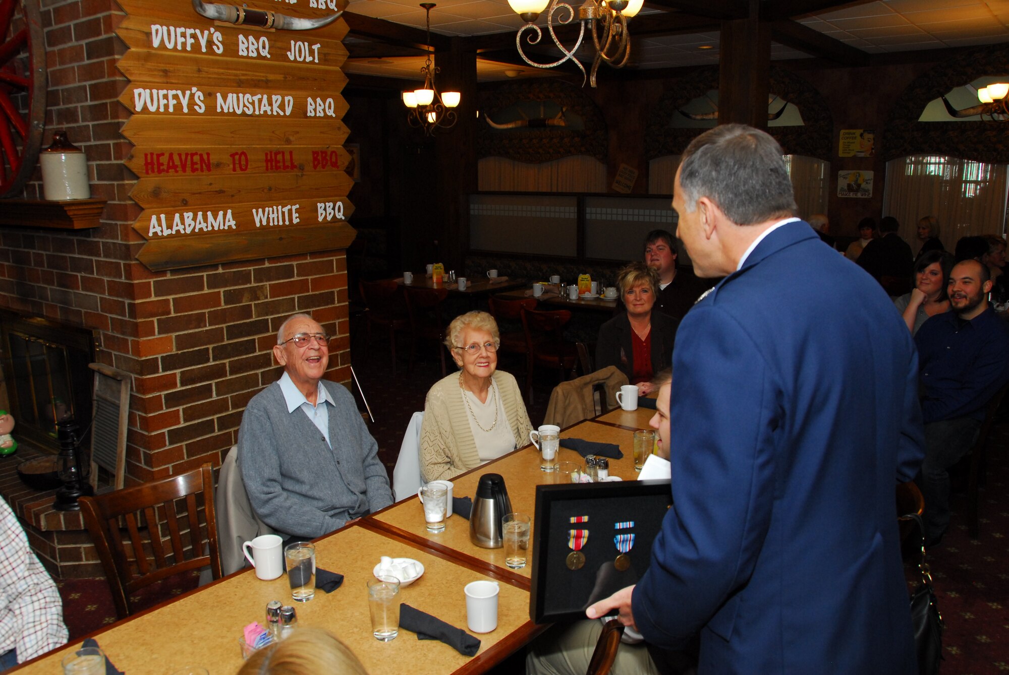 Sixty Four years later Colonel Gunther Neumann, director of operation for the Wisconsin Air National Guard presents Mr. Bill Morstad (left) with a shadow box filled with medals he earned during four years of service during World War II.  Corporal Morstad enlisted in the Army Air Corps in June of 1941 and served overseas as a radio operator and air traffic controller until the end of the war in 1945. (U.S. Air Force photo by Master Sgt. Dan Richardson)