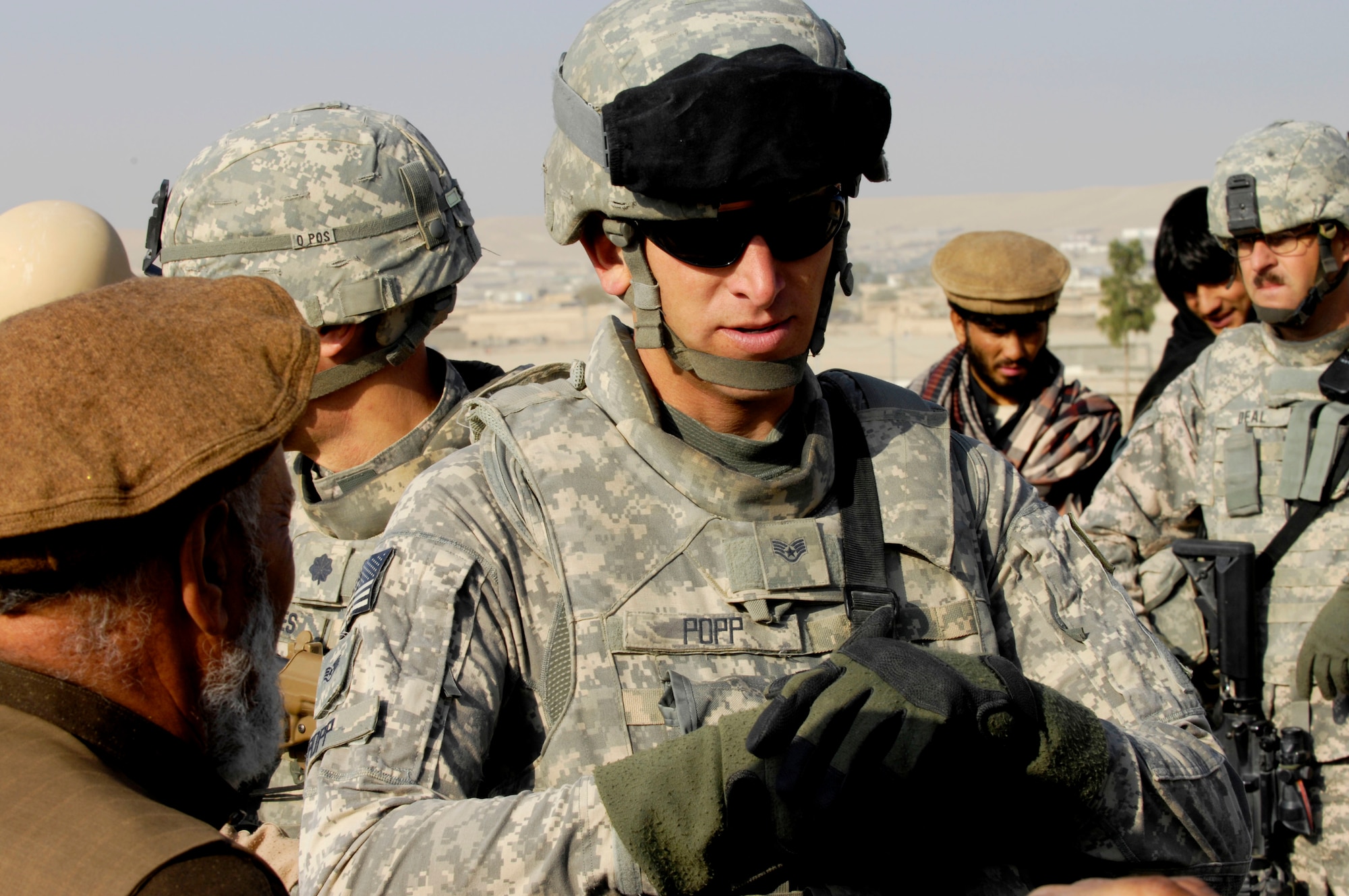 Staff Sgt. David Popp, a security forces Airman assigned to the Zabul Provincial Reconstruction Team, meets with Afghan prison officials during a mentoring session Oct. 28, 2009. Sergeant Popp, who is deployed to the region from Creech Air Force Base, Nev., plans to work with the guards, helping them become better at handling prisoners within the compound.  The mission is just one of many the PRT takes on, which can range from foot patrols to working with government officials. (U.S. Air Force photo/Tech. Sgt. Joseph Kapinos)