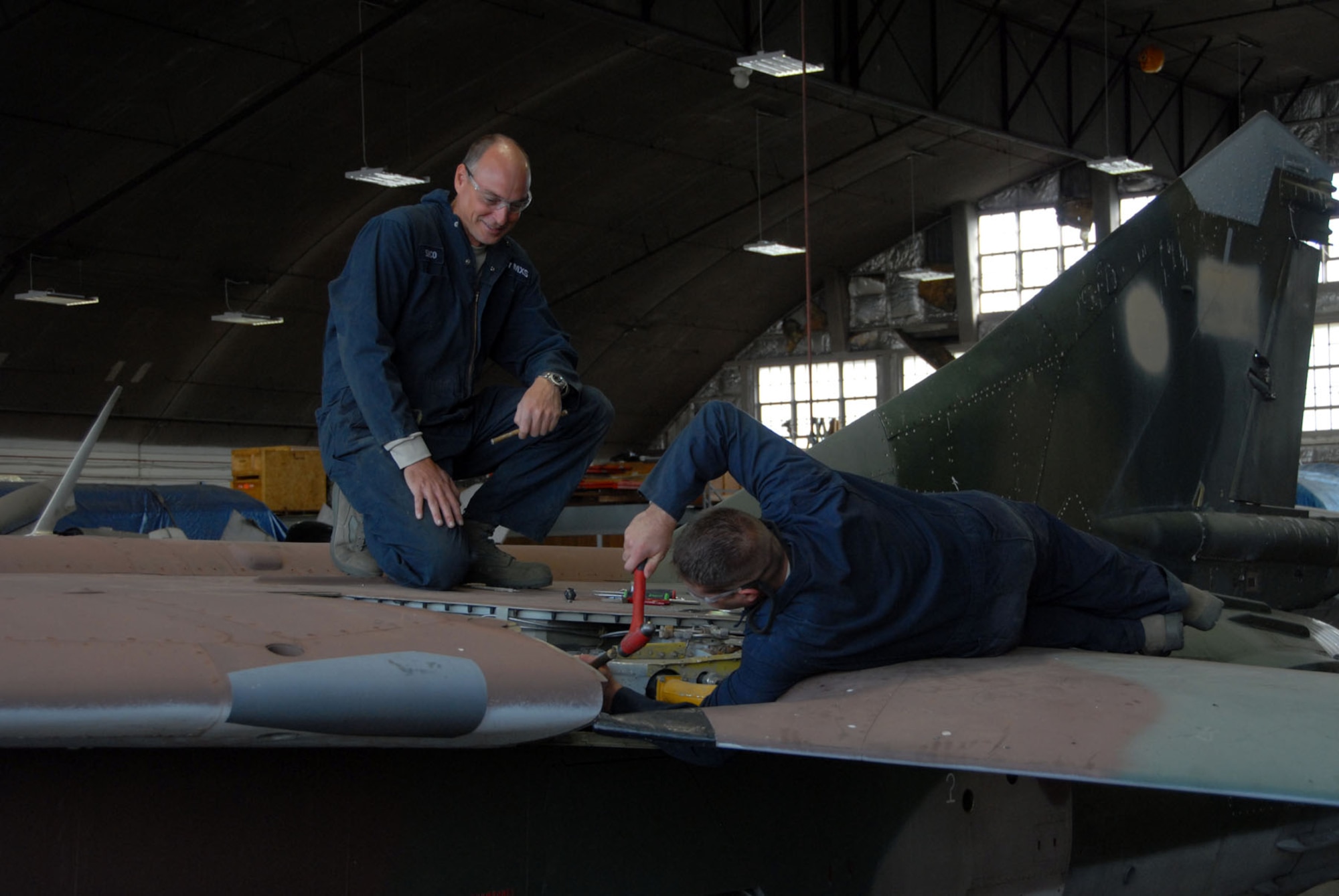 DAYTON, Ohio - Members of the 315th Maintenance Squadron out of Charleston Air Force Base, S.C., work to remove a wing from a MiG-23 during their two-week stay at Wright-Patterson Air Force Base, Ohio, where the group worked in the restoration hangar at the National Museum of the U.S. Air Force. (U.S. Air Force photo)