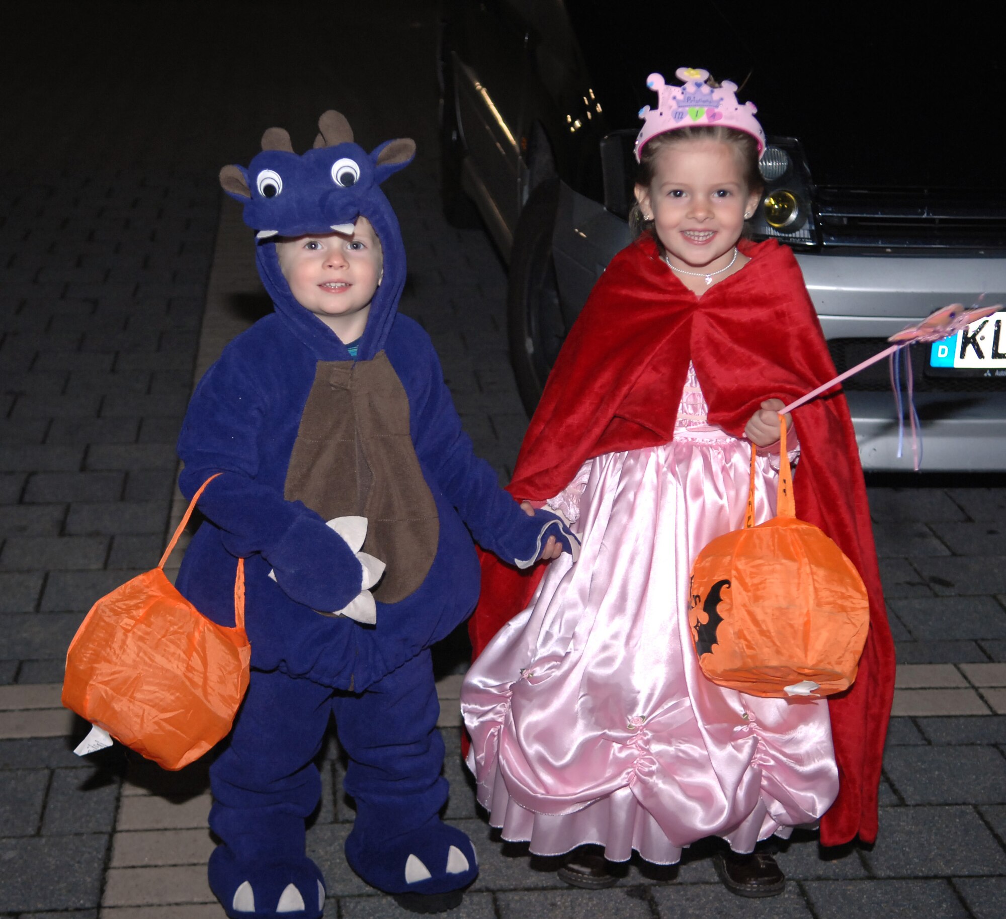 Bradley and Mia Drake, dependents of Rene and Staff Sgt. Alan Drake, 886th Civil Engineer Squadron firefighter, pose in their Halloween costumes before heading out for a night of trick-or-treating, Oct. 31, 2009. This year many of the housing areas on Ramstein Air Base as well as local German communities were filled with the more than 54 thousand Kaiserslautern Military Community servicemembers enjoying Halloween. (U.S. Air Force photo by Tech. Sgt. Michael Voss)