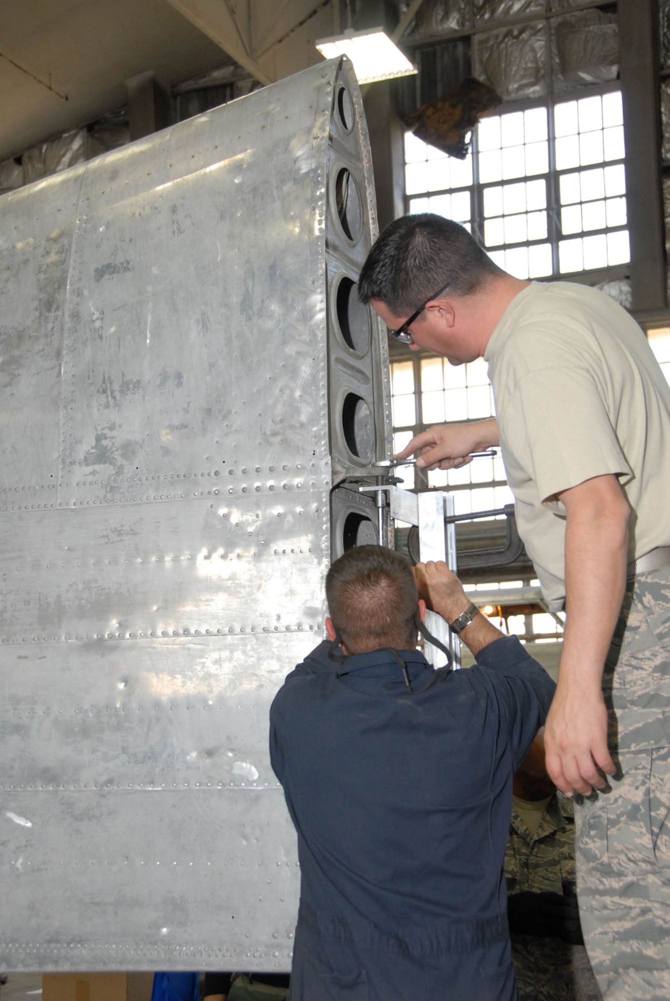 DAYTON, Ohio - Members of the 315th Maintenance Squadron out of Charleston Air Force Base, S.C., piece together a holding fixture for the B-17F Memphis Belle's wing during their two-week stay at Wright-Patterson Air Force Base, Ohio, where the group worked in the restoration hangar at the National Museum of the U.S. Air Force. (U.S. Air Force photo)