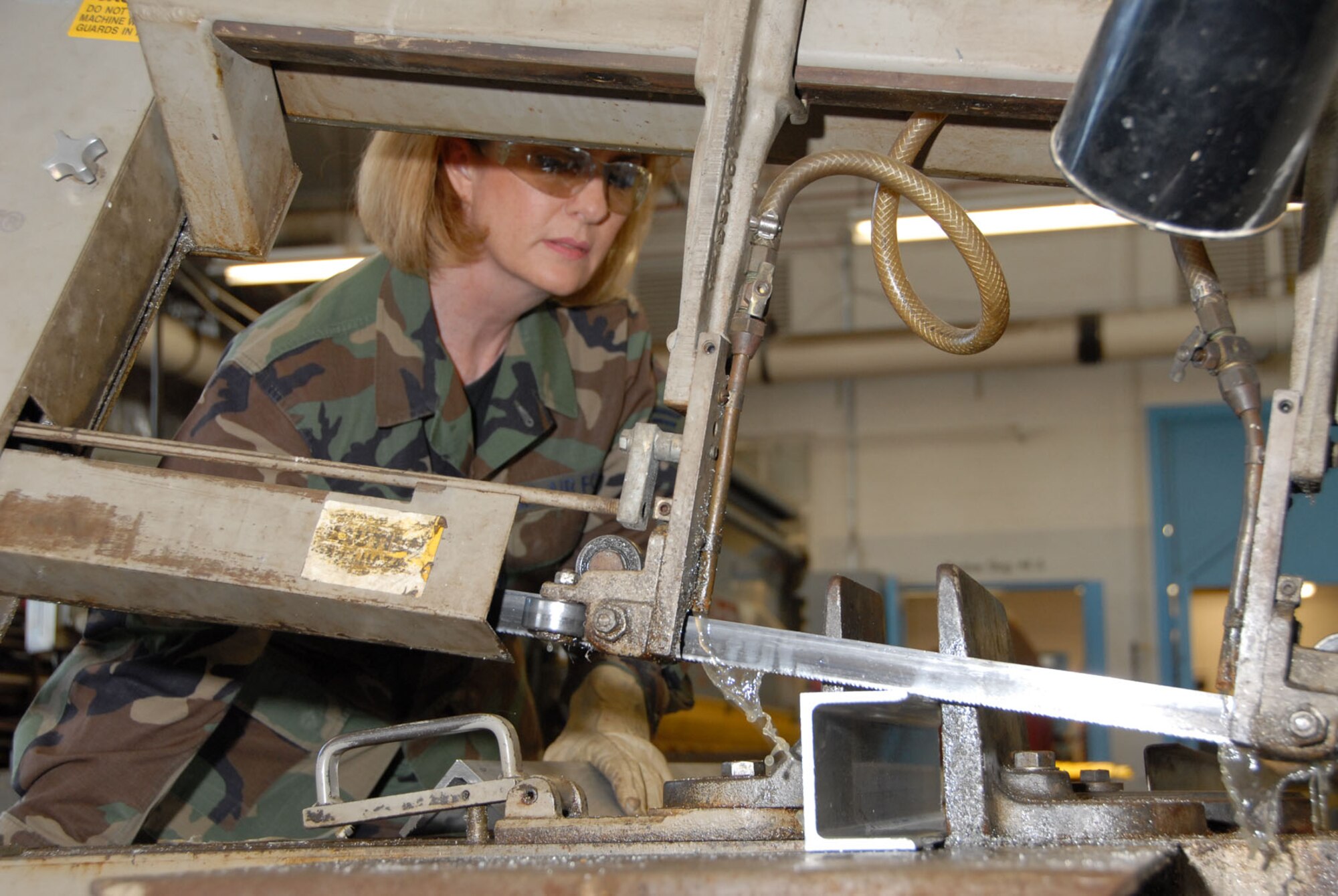 DAYTON, Ohio - Tech. Sgt. Sherri St. John, a reservist with the 315th Maintenance Squadron at Charleston Air Force Base, S.C., saws a piece of stock metal during her two-week stay at Wright-Patterson Air Force Base, Ohio, where she worked in the restoration hangar at the National Museum of the U.S. Air Force. (U.S. Air Force photo)