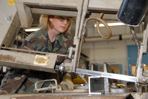 DAYTON, Ohio - Tech. Sgt. Sherri St. John, a reservist with the 315th Maintenance Squadron at Charleston Air Force Base, S.C., saws a piece of stock metal during her two-week stay at Wright-Patterson Air Force Base, Ohio, where she worked in the restoration hangar at the National Museum of the U.S. Air Force. (U.S. Air Force photo)
