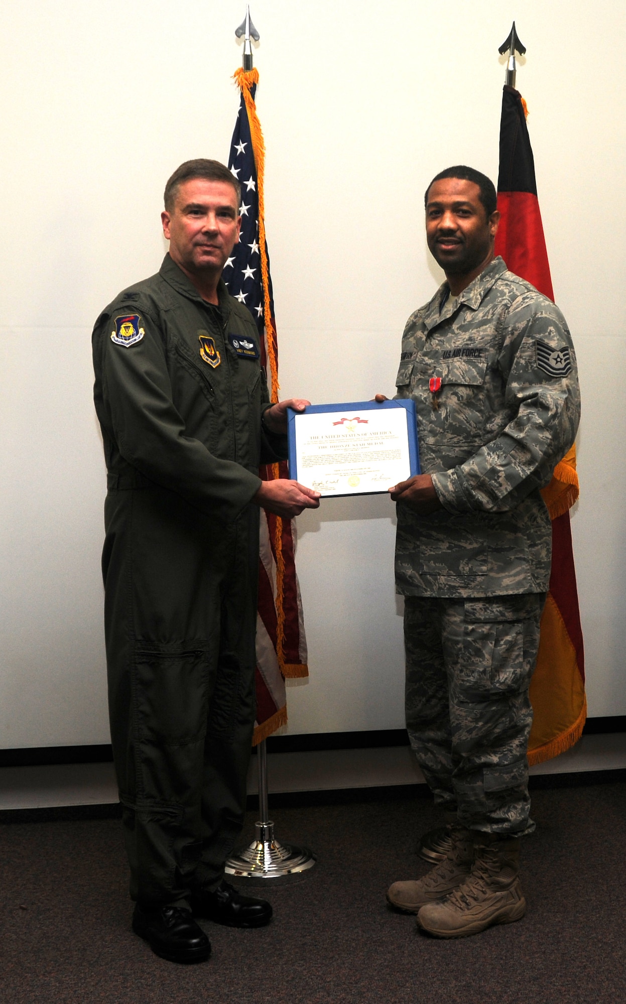 RAMSTEIN AIR BASE, Germany -- Tech Sgt. Willie Thompson (right), 17th Air
Force, joins 617th Air and Space Operations Center Commander Col. Andy
Redmond in displaying his certificate after receiving the Bronze Star Oct. 20.
Colonel Redmond decorated Sergeant Thompson for exceptional performance and
dedication to duty while serving in Iraq from August of 2008 to February of
2009. During this tour, Sergeant Thompson served as the NCO in charge of
operations for a task force involved in high-priority combat missions. In
the medal citation, Army Maj. Gen. Joseph Votel lauded the NCO's leadership
and organizational skills as playing a "critical role" in mission
accomplishment. Congratulations Sergeant Thompson! (USAF photo by Master
Sgt. Jim Fisher)  
