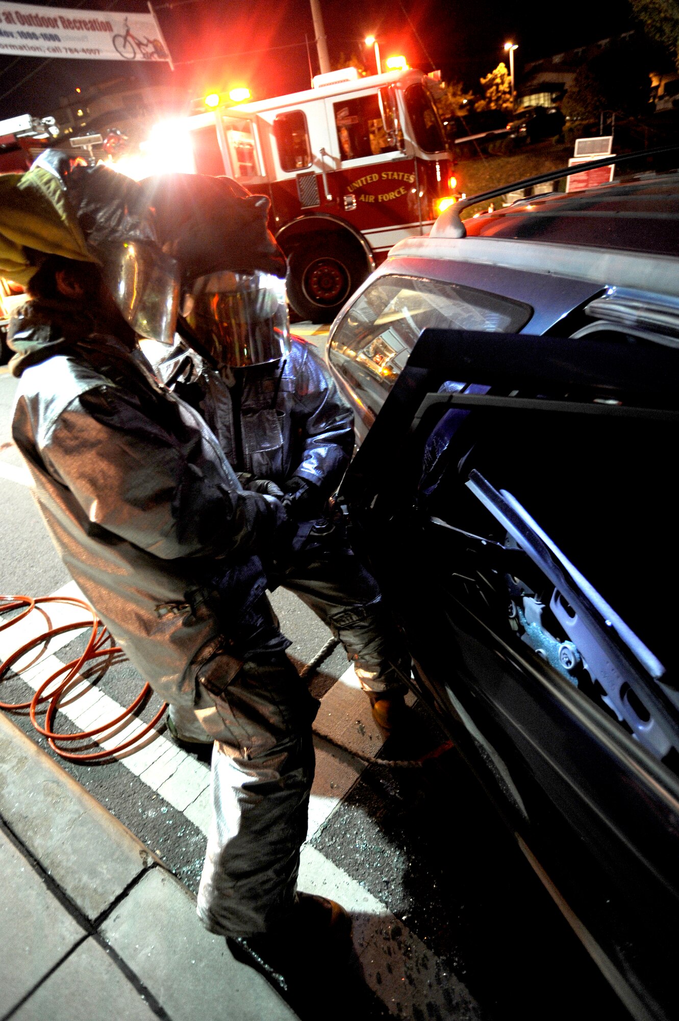 Fire fighters from the 51st Civil Engineer Squadron use the jaws of life on a car door during a simulated car accident at Osan Air Base, Republic of Korea, Nov. 2.  The simulation is part of operational readiness exercise Beverly Midnight 09-02. (U.S. Air Force photo/Staff Sgt. Brian Ferguson)