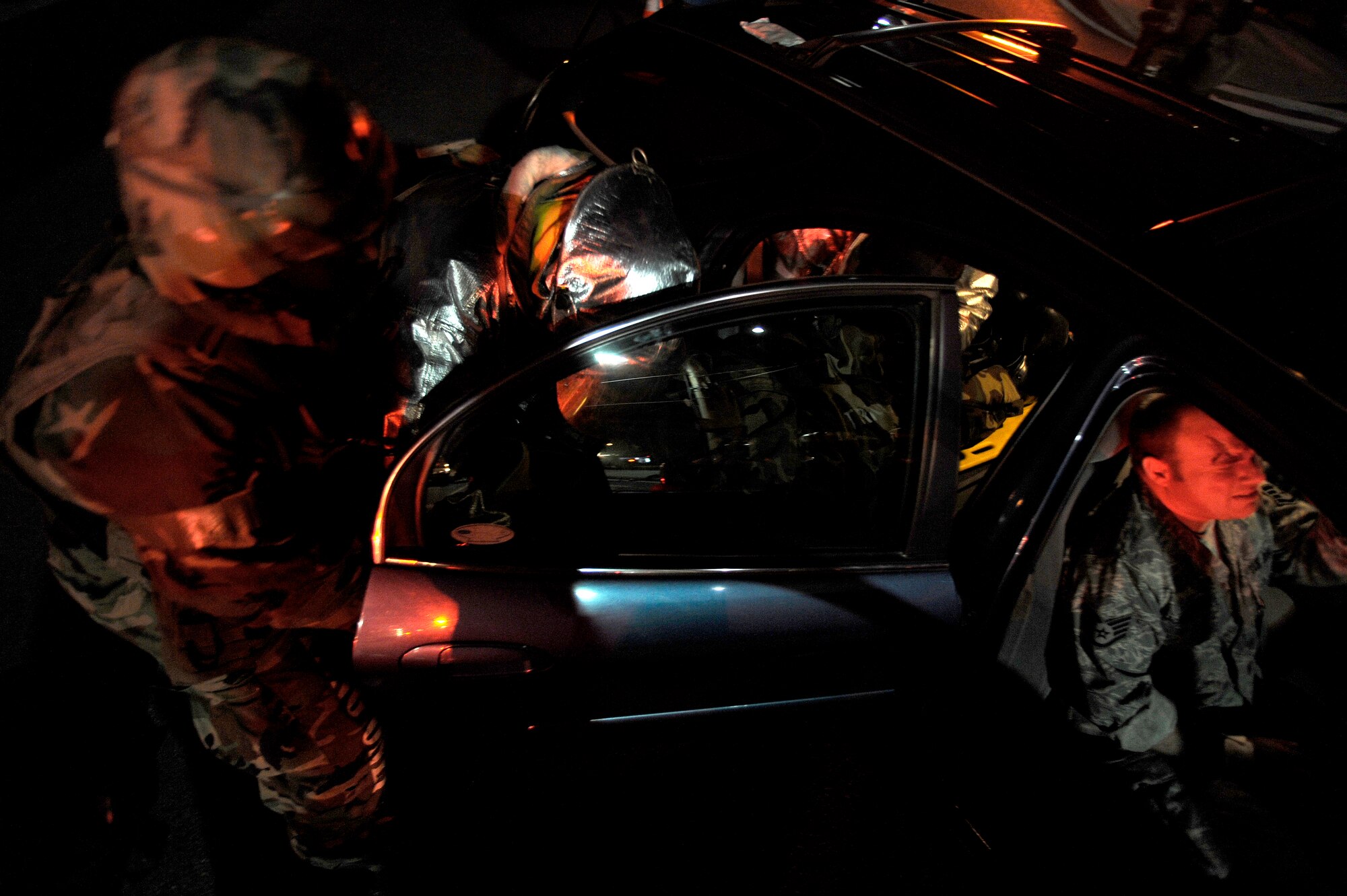 Fire fighters from the 51st Civil Engineer Squadron help a passenger of a simulated car accident at Osan Air Base, Republic of Korea, Nov. 2.  The simulation is part of operational readiness exercise Beverly Midnight 09-02. (U.S. Air Force photo/Staff Sgt. Brian Ferguson)