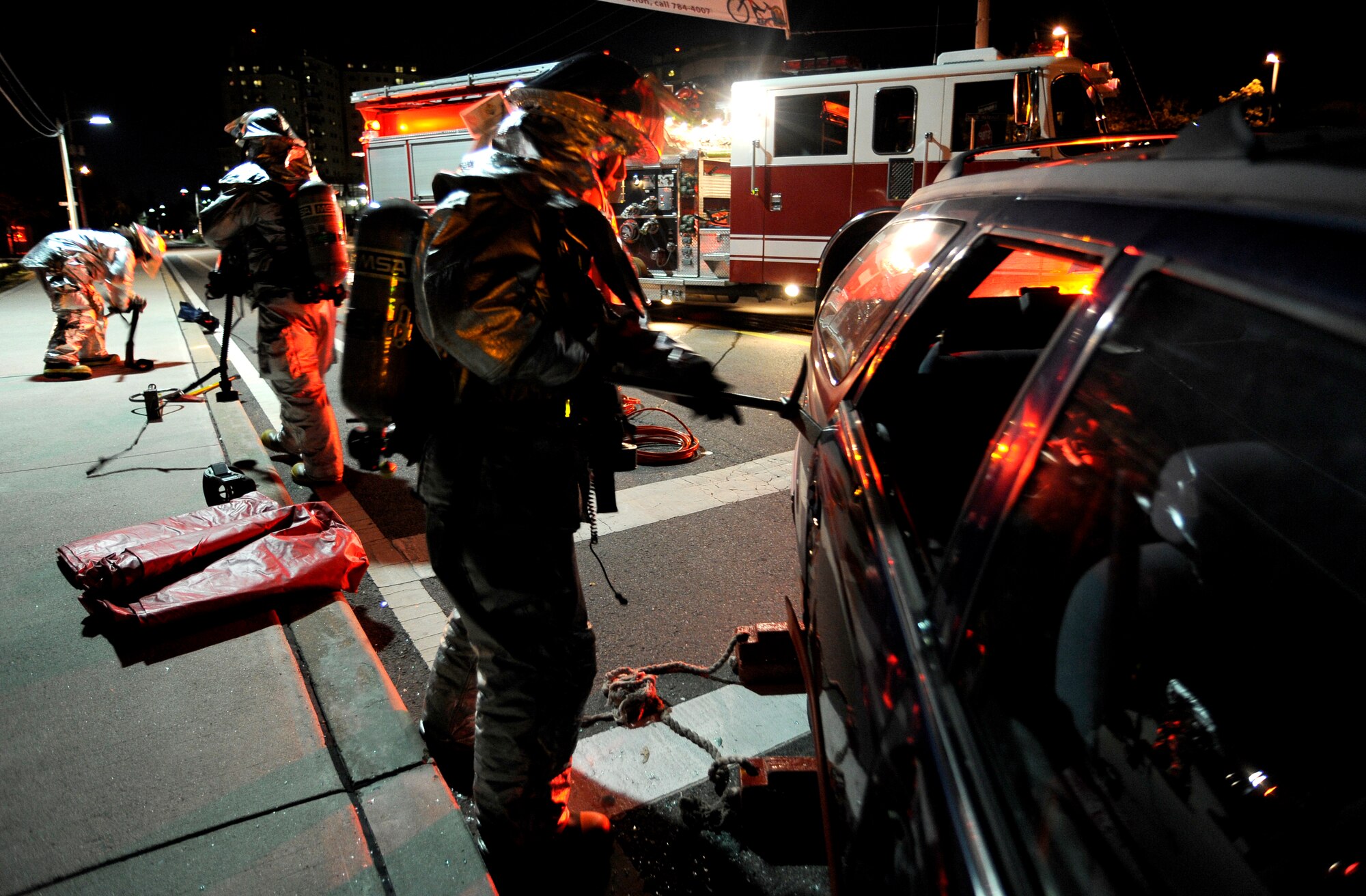 Fire fighters from the 51st Civil Engineer Squadron prepare to use the jaws of life on a car door during a simulated car accident at Osan Air Base, Republic of Korea, Nov. 2.  The simulation is part of operational readiness exercise Beverly Midnight 09-02. (U.S. Air Force photo/Staff Sgt. Brian Ferguson)