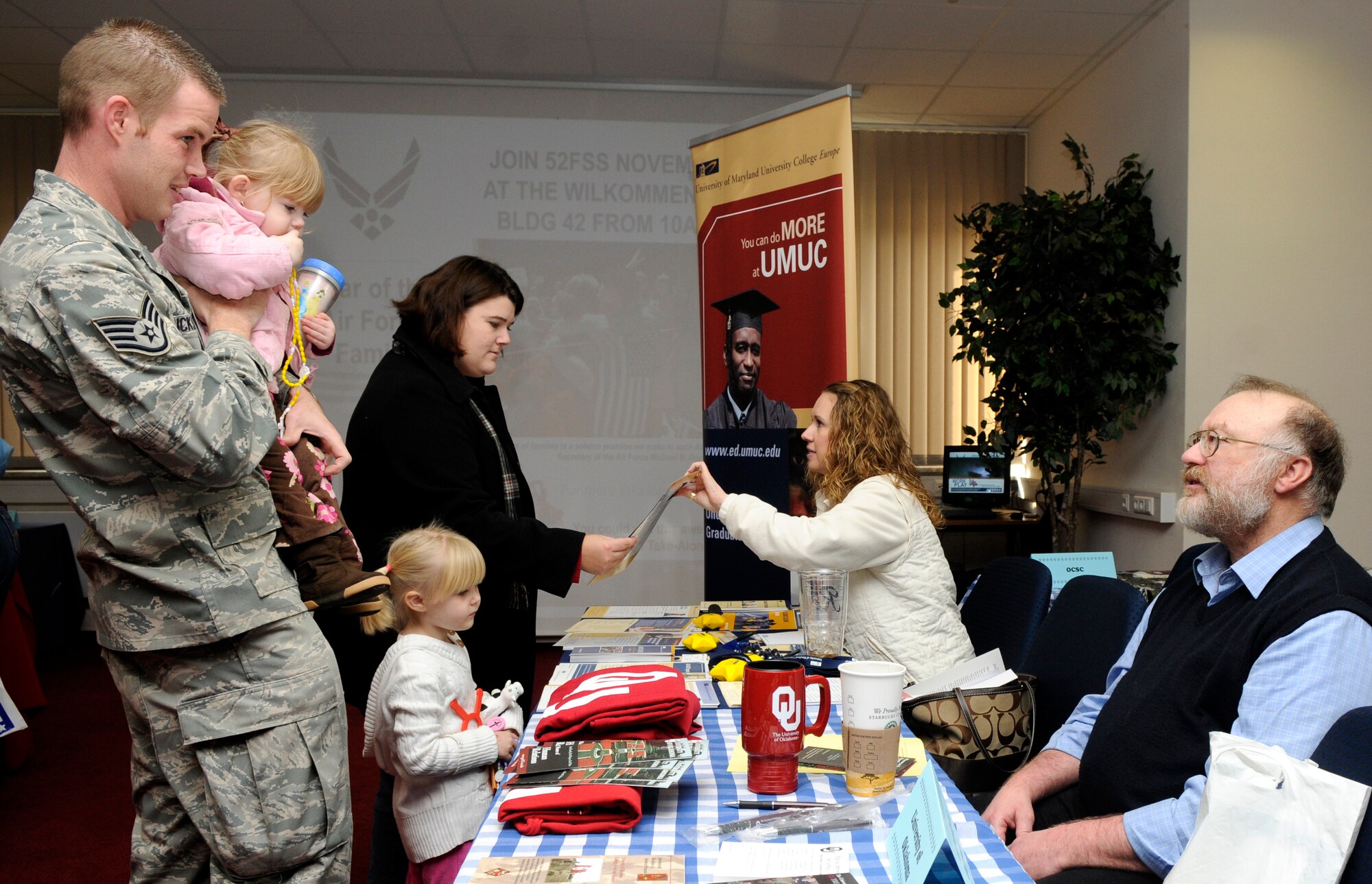 SPANGDAHLEM AIR BASE, Germany – Staff Sgt. Todd Dickson, 52nd Equipment Maintenance Squadron, wife, Shanna, and daughters, Hannah and Sophie, explore the Year of the Air Force Family Information Fair held at the Wilkommen Center Nov. 2. The information fair had about 30 different organizations aimed to support the Air Force family. (U.S. Air Force photo/Airman 1st Class Staci Miller)