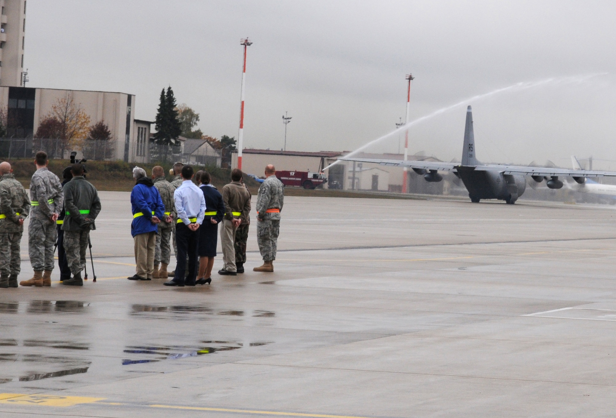 The 835th Civil Engineer Squadron fire department performs a water-gun salute as Ramstein's last C-130E Hercules taxies down the flight line for departure, Ramstein Air Base, Germany, Nov. 2, 2009.  The C-130E Hercules has provided more than 40 years of airpower to U.S.  Air Forces in Europe, and is being replaced with the new C-130J Super Hercules as part of the revitalization of the Air Force fleet. (U.S. Air Force photo by Airman 1st Class Caleb Pierce)