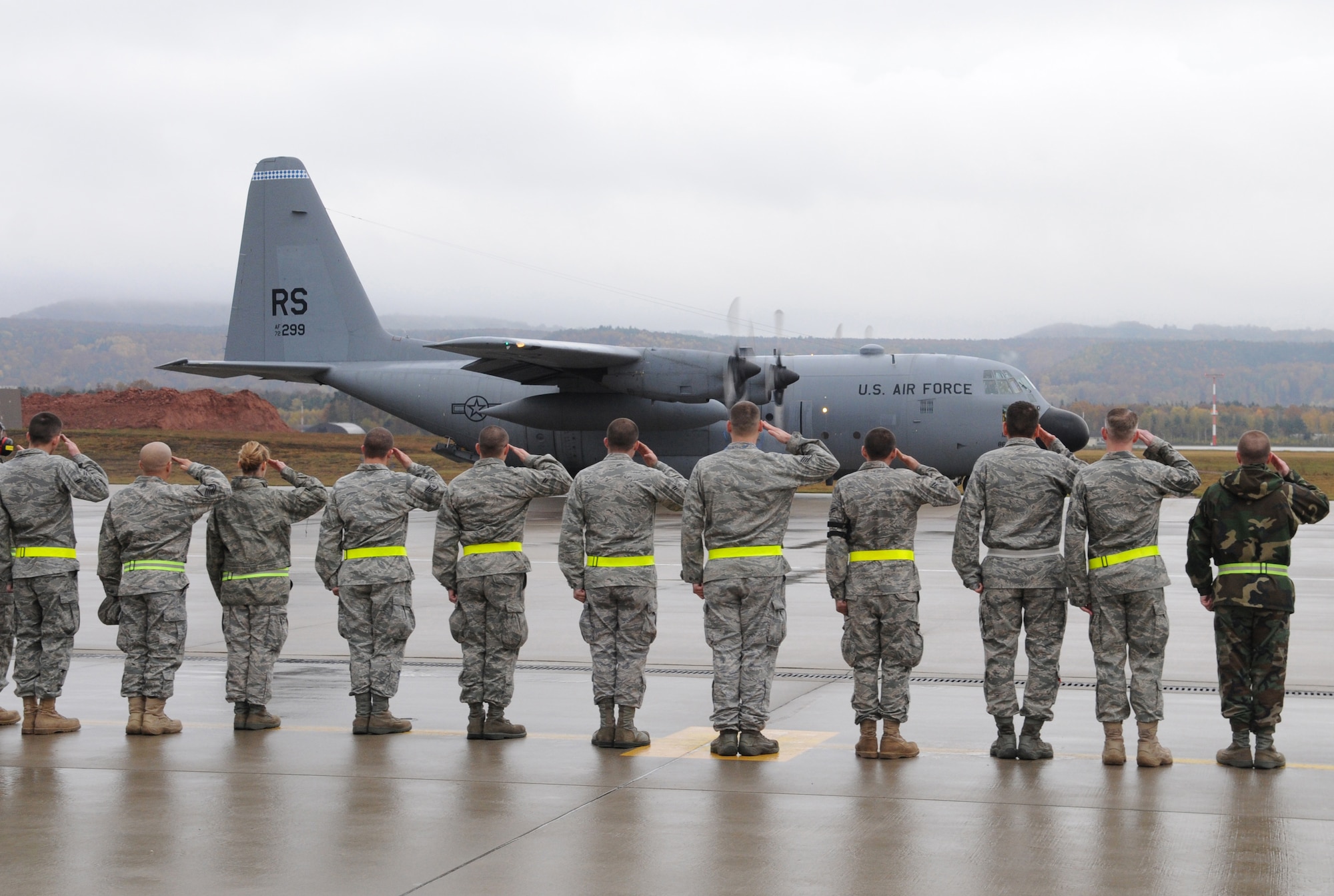 U.S. Air Force Airmen from the 86th Aircraft Maintenance Squadron render salutes to Ramstein's last C-130E Hercules while it taxies down the flight line for departure, Ramstein Air Base, Germany, Nov. 2, 2009.  The C-130E Hercules has provided more than 40 years of airpower to U.S. Air Forces in Europe, and is being replaced with the new C-130J Super Hercules as part of the revitalization of the Air Force fleet. (U.S. Air Force photo by Airman 1st Class Caleb Pierce)
