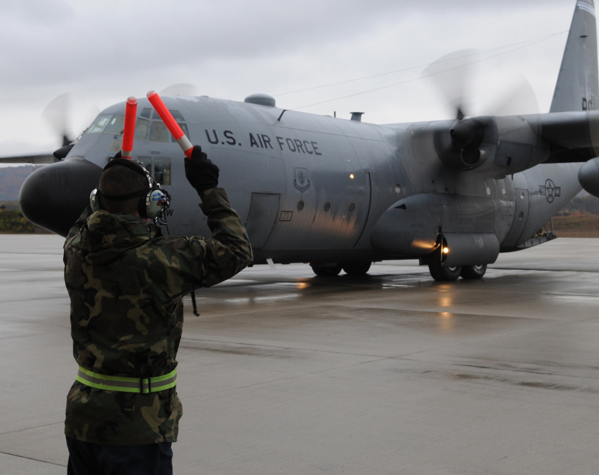 U.S. Air Force Senior Airman Jason Ricke, 86th Aircraft Maintenance Squadron crew chief, marshals Ramstein's last C-130E Hercules onto the flight line for departure, Ramstein Air Base, Germany, Nov. 2, 2009.  The C-130E Hercules has provided more than 40 years of airpower to U.S.  Air Forces Europe, and has been upgraded to the new C-130J Super Hercules as part of revitalizing the Air Force fleet. (U.S. Air Force photo by Airman 1st Class Caleb Pierce)