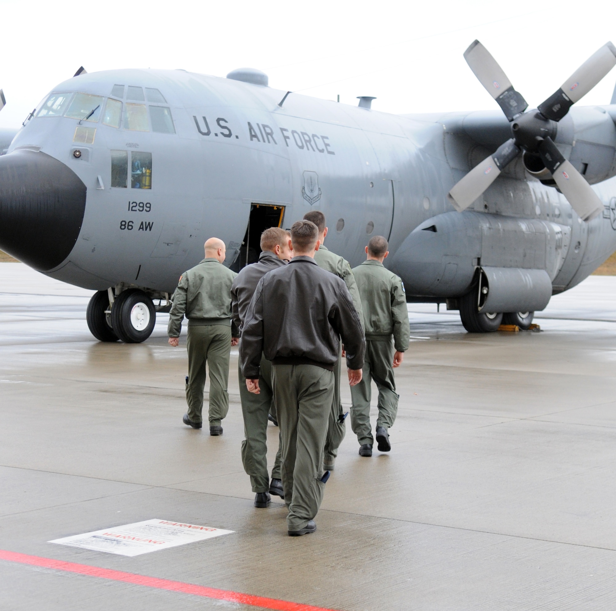 A U.S. Air Force flight crew boards Ramstein's last C-130E Hercules in preparation for final departure on Ramstein Air Base, Germany, Nov., 2, 2009. The C-130E Hercules has provided more than 40 years of airpower to U.S.  Air Forces in Europe, and is being replaced with the new C-130J Super Hercules as part of the revitalization of the Air Force fleet. (U.S. Air Force photo by Airman 1st Class Caleb Pierce)