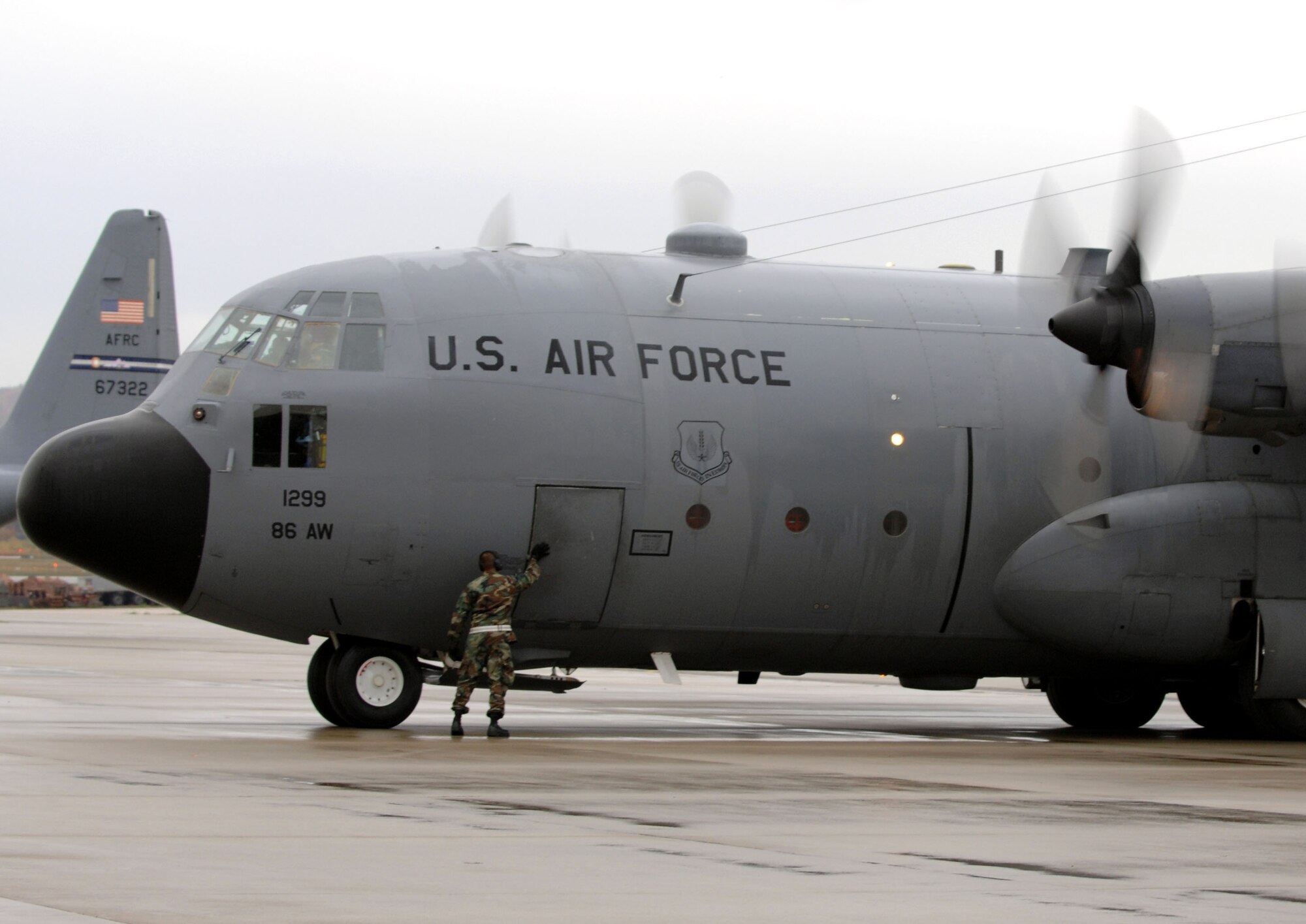 U.S. Air Force Staff Sgt. Nate McAdams, 86th Aircraft Maintenance Squadron crew chief, closes the door of Ramstein's last C-130E Hercules in preparation for final departure on Ramstein Air Base, Germany, Nov. 2, 2009. The C-130E Hercules has provided more than 40 years of airpower to U.S.  Air Forces in Europe, and has been upgraded to the new C-130J Super Hercules as part of revitalizing the Air Force fleet. (U.S. Air Force photo by Airman 1st Class Brittany Perry)