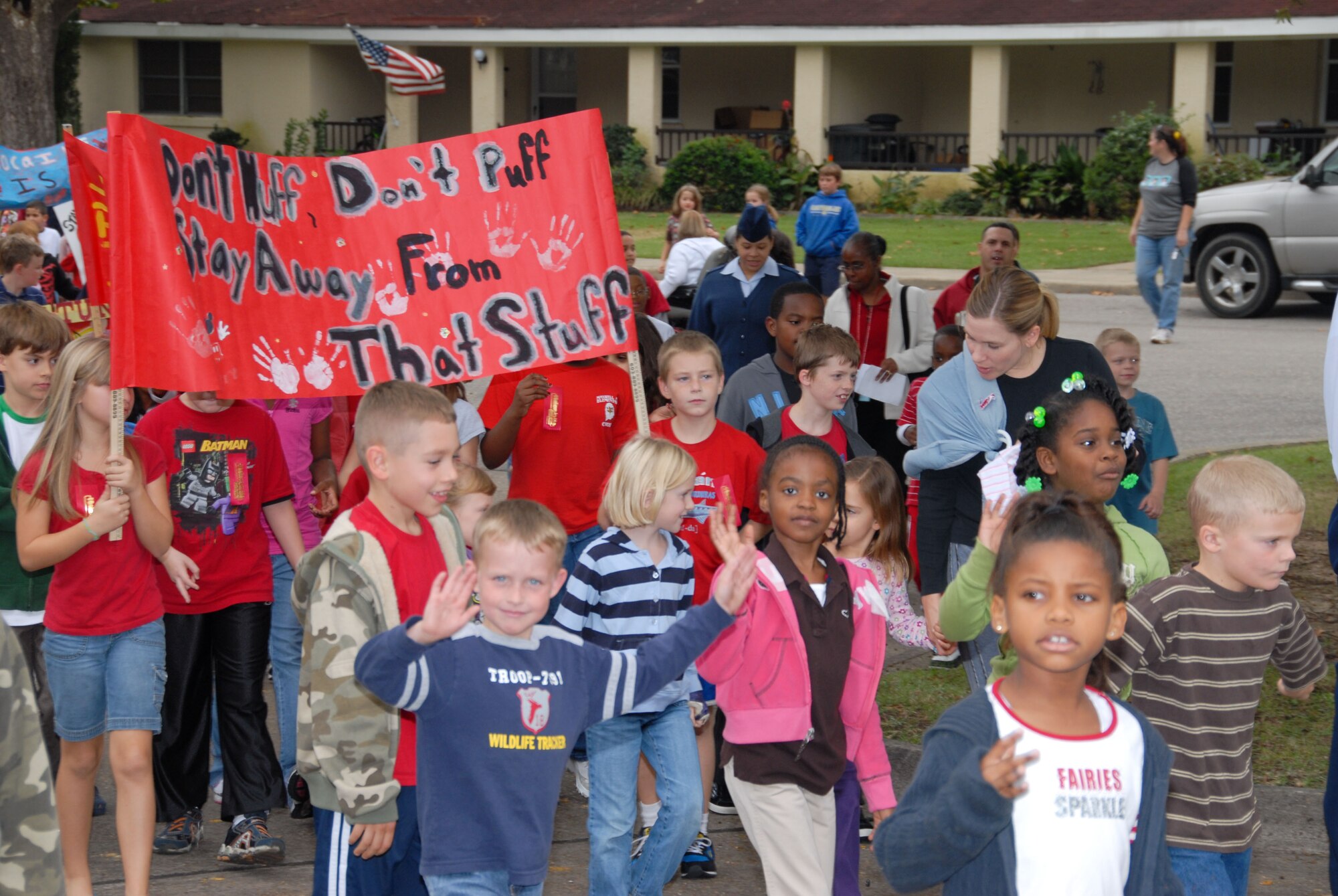 As part of the national Red Ribbon Week, students from Maxwell Elementary School “marched away from drugs” with a parade down Maxwell’s Magnolia Street to the base arboretum Monday. At the arboretum, the students placed red ribbons around the trees and pledged to stay drug free. Normally held the last week in October, Red Ribbon Week is a national campaign for drug prevention. (U.S. Air Force photo/Bud Hancock)

