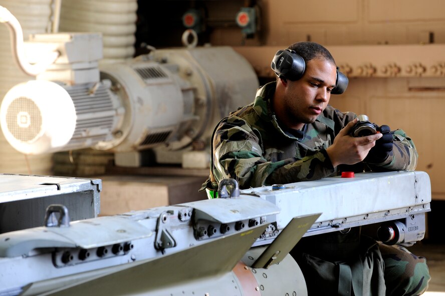 Senior Airman Andre James examines a part belonging to a maverick missile, prepping it to be loaded onto an aircraft in a 25th Fighter Squadron hangar during exercise Beverly Midnight 09-02 on Osan Air Base, Nov. 2. (U.S. Air Force photo/ Senior Airman Stephenie Wade)